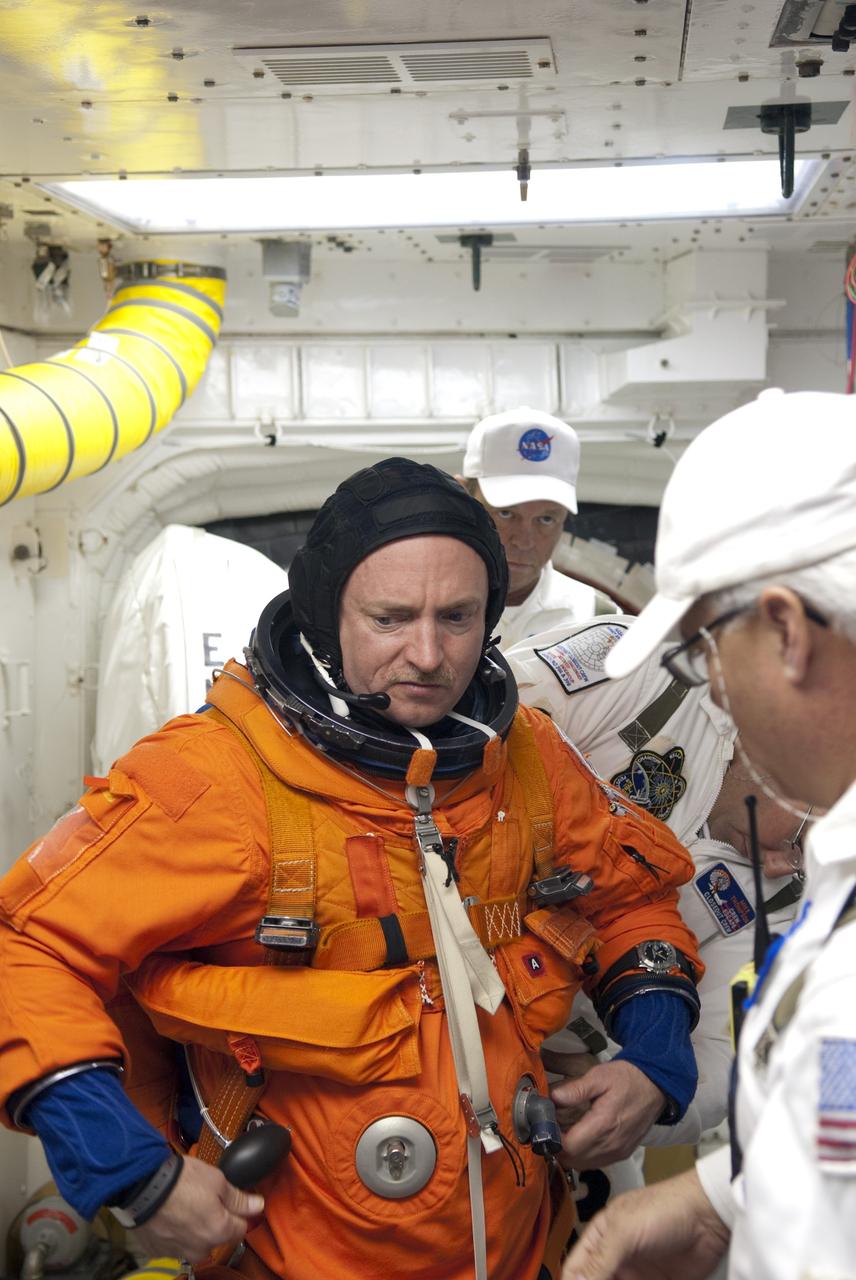 CAPE CANAVERAL, Fla. - In the White Room of Launch Pad 39A at NASA's Kennedy Space Center in Florida, STS-134 Commander Mark Kelly prepares to board space shuttle Endeavour during the Terminal Countdown Demonstration Test (TCDT). Part of TCDT includes practicing the final hours of a real launch day when astronauts put on their launch-and-entry suits, ride to the pad in the Astrovan and strap into the shuttle.    Endeavour's six crew members are targeted to launch April 19 at 7:48 p.m. EDT. They will deliver the Express Logistics Carrier-3, Alpha Magnetic Spectrometer-2 (AMS), a high-pressure gas tank, additional spare parts for the Dextre robotic helper and micrometeoroid debris shields to the International Space Station. This will be the final spaceflight for Endeavour. For more information visit, www.nasa.gov/mission_pages/shuttle/shuttlemissions/sts134/index.html. Photo credit: NASA/Jim Grossmann