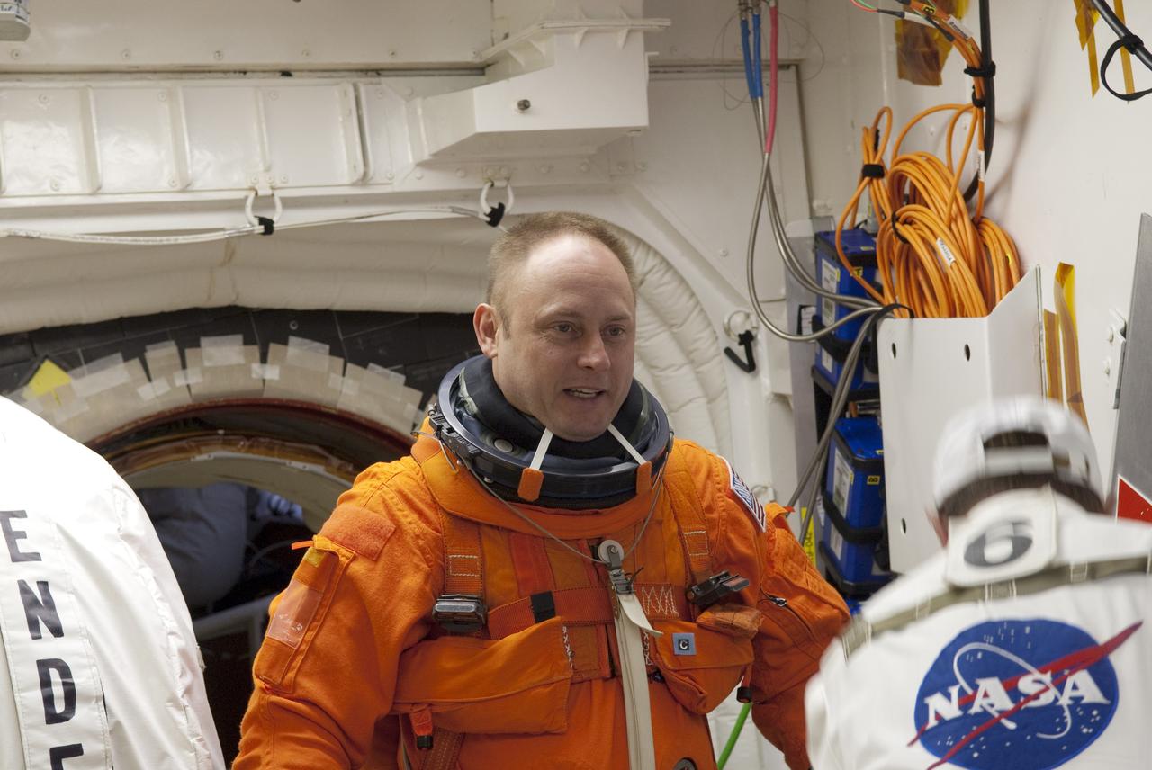 CAPE CANAVERAL, Fla. -- In the White Room of Launch Pad 39A at NASA's Kennedy Space Center in Florida, STS-134 Mission Specialist Michael Fincke prepares to board space shuttle Endeavour during the Terminal Countdown Demonstration Test (TCDT). Part of TCDT includes practicing the final hours of a real launch day when astronauts put on their launch-and-entry suits, ride to the pad in the Astrovan and strap into the shuttle.    Endeavour's six crew members are targeted to launch April 19 at 7:48 p.m. EDT. They will deliver the Express Logistics Carrier-3, Alpha Magnetic Spectrometer-2 (AMS), a high-pressure gas tank, additional spare parts for the Dextre robotic helper and micrometeoroid debris shields to the International Space Station. This will be the final spaceflight for Endeavour. For more information visit, www.nasa.gov/mission_pages/shuttle/shuttlemissions/sts134/index.html. Photo credit: NASA/Jim Grossmann