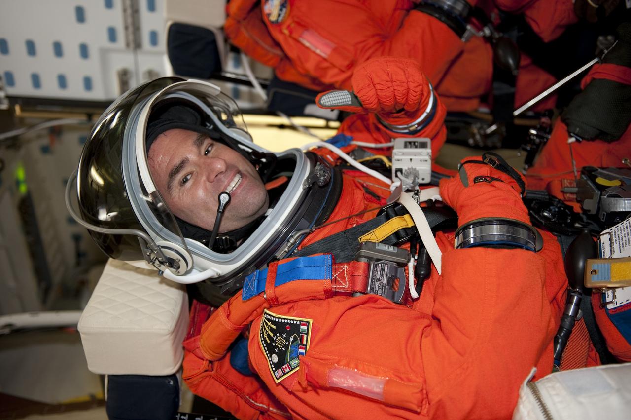 CAPE CANAVERAL, Fla. - STS-134 Mission Specialist Greg Chamitoff gives a thumbs-up as he takes his seat aboard space shuttle Endeavour during the Terminal Countdown Demonstration Test (TCDT) on Launch Pad 39A at NASA's Kennedy Space Center in Florida. Part of TCDT includes practicing the final hours of a real launch day when astronauts put on their launch-and-entry suits, ride to the pad in the Astrovan and strap into the shuttle. Endeavour's six crew members are targeted to launch April 19 at 7:48 p.m. EDT. They will deliver the Express Logistics Carrier-3, Alpha Magnetic Spectrometer-2 (AMS), a high-pressure gas tank, additional spare parts for the Dextre robotic helper and micrometeoroid debris shields to the International Space Station. This will be the final spaceflight for Endeavour. For more information visit, www.nasa.gov/mission_pages/shuttle/shuttlemissions/sts134/index.html. Photo credit: NASA/Kim Shiflett