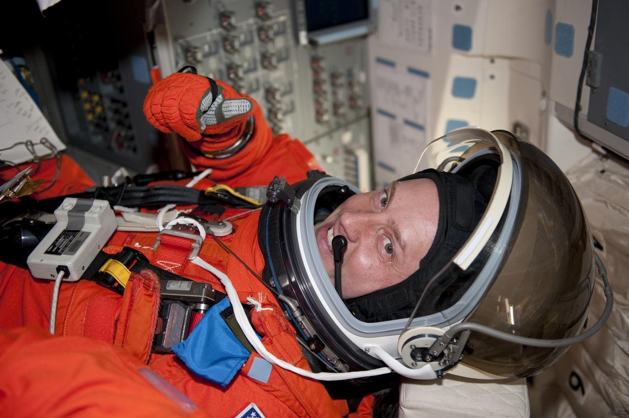 CAPE CANAVERAL, Fla. -- STS-134 Mission Specialist Michael Fincke gives a thumbs-up as he takes his seat aboard space shuttle Endeavour during the Terminal Countdown Demonstration Test (TCDT) on Launch Pad 39A at NASA's Kennedy Space Center in Florida. Part of TCDT includes practicing the final hours of a real launch day when astronauts put on their launch-and-entry suits, ride to the pad in the Astrovan and strap into the shuttle. Endeavour's six crew members are targeted to launch April 19 at 7:48 p.m. EDT. They will deliver the Express Logistics Carrier-3, Alpha Magnetic Spectrometer-2 (AMS), a high-pressure gas tank, additional spare parts for the Dextre robotic helper and micrometeoroid debris shields to the International Space Station. This will be the final spaceflight for Endeavour. For more information visit, www.nasa.gov/mission_pages/shuttle/shuttlemissions/sts134/index.html. Photo credit: NASA/Kim Shiflett