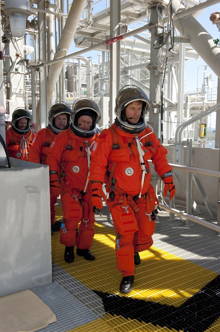 CAPE CANAVERAL, Fla. - During a simulated pad emergency on Launch Pad 39A at NASA's Kennedy Space Center in Florida, STS-134 Mission Specialists Roberto Vittori, with the European Space Agency, front, and Michael Fincke, Pilot Greg H. Johnson, and Commander Mark Kelly make their way toward a slidewire basket that would take them to a safe bunker below the pad in an unlikely emergency situation. The emergency training while aboard space shuttle Endeavour is part of a week-long Terminal Countdown Demonstration Test (TCDT). Endeavour's six crew members are targeted to launch April 19 at 7:48 p.m. EDT. They will deliver the Express Logistics Carrier-3, Alpha Magnetic Spectrometer-2 (AMS), a high-pressure gas tank, additional spare parts for the Dextre robotic helper and micrometeoroid debris shields to the International Space Station. This will be the final spaceflight for Endeavour. For more information visit, www.nasa.gov/mission_pages/shuttle/shuttlemissions/sts134/index.html. Photo credit: NASA/Kim Shiflett