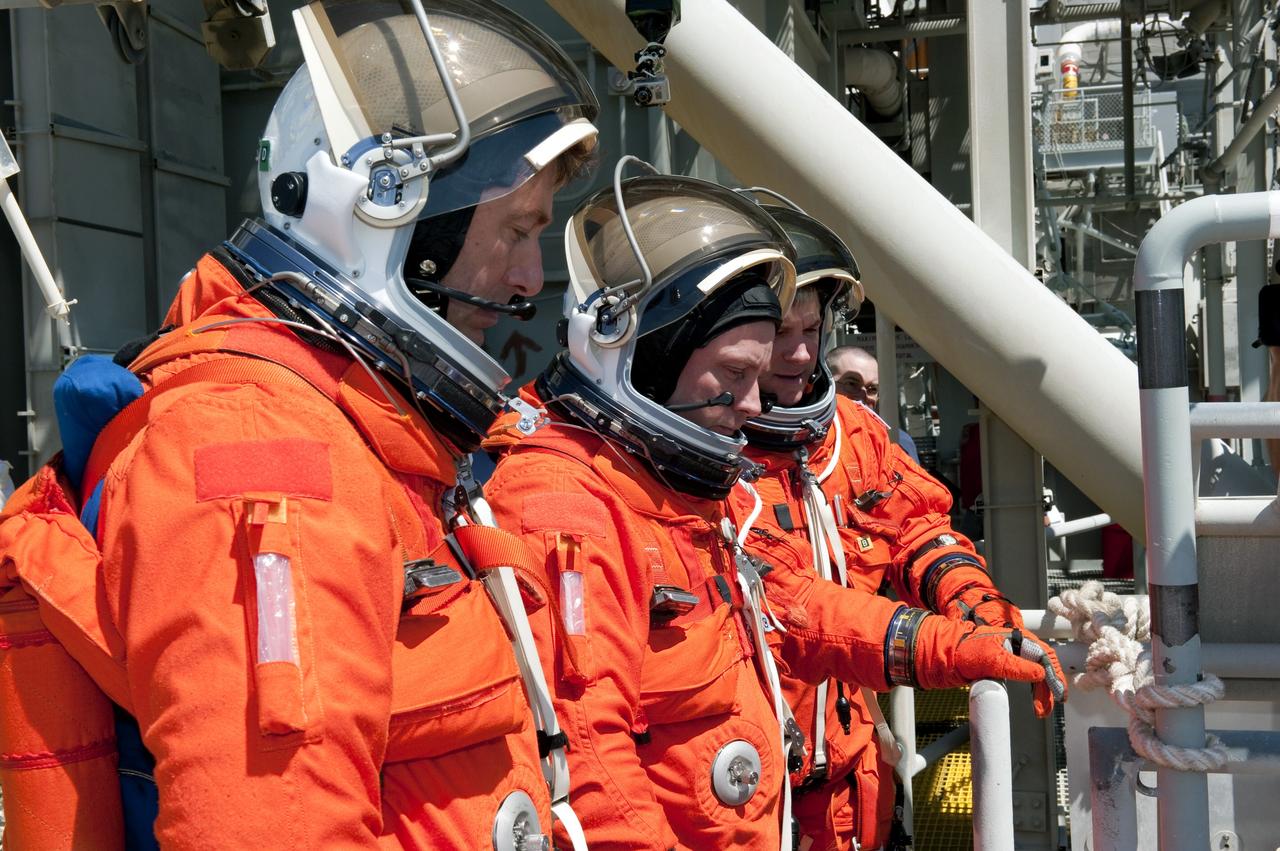 CAPE CANAVERAL, Fla. - During a simulated pad emergency on Launch Pad 39A at NASA's Kennedy Space Center in Florida, STS-134 Mission Specialists Roberto Vittori, with the European Space Agency, left, and Michael Fincke, and Pilot Greg H. Johnson check out a slidewire basket that would take them to a safe bunker below the pad in an unlikely emergency situation. The emergency training while aboard space shuttle Endeavour is part of a week-long Terminal Countdown Demonstration Test (TCDT). Endeavour's six crew members are targeted to launch April 19 at 7:48 p.m. EDT. They will deliver the Express Logistics Carrier-3, Alpha Magnetic Spectrometer-2 (AMS), a high-pressure gas tank, additional spare parts for the Dextre robotic helper and micrometeoroid debris shields to the International Space Station. This will be the final spaceflight for Endeavour. For more information visit, www.nasa.gov/mission_pages/shuttle/shuttlemissions/sts134/index.html. Photo credit: NASA/Kim Shiflett