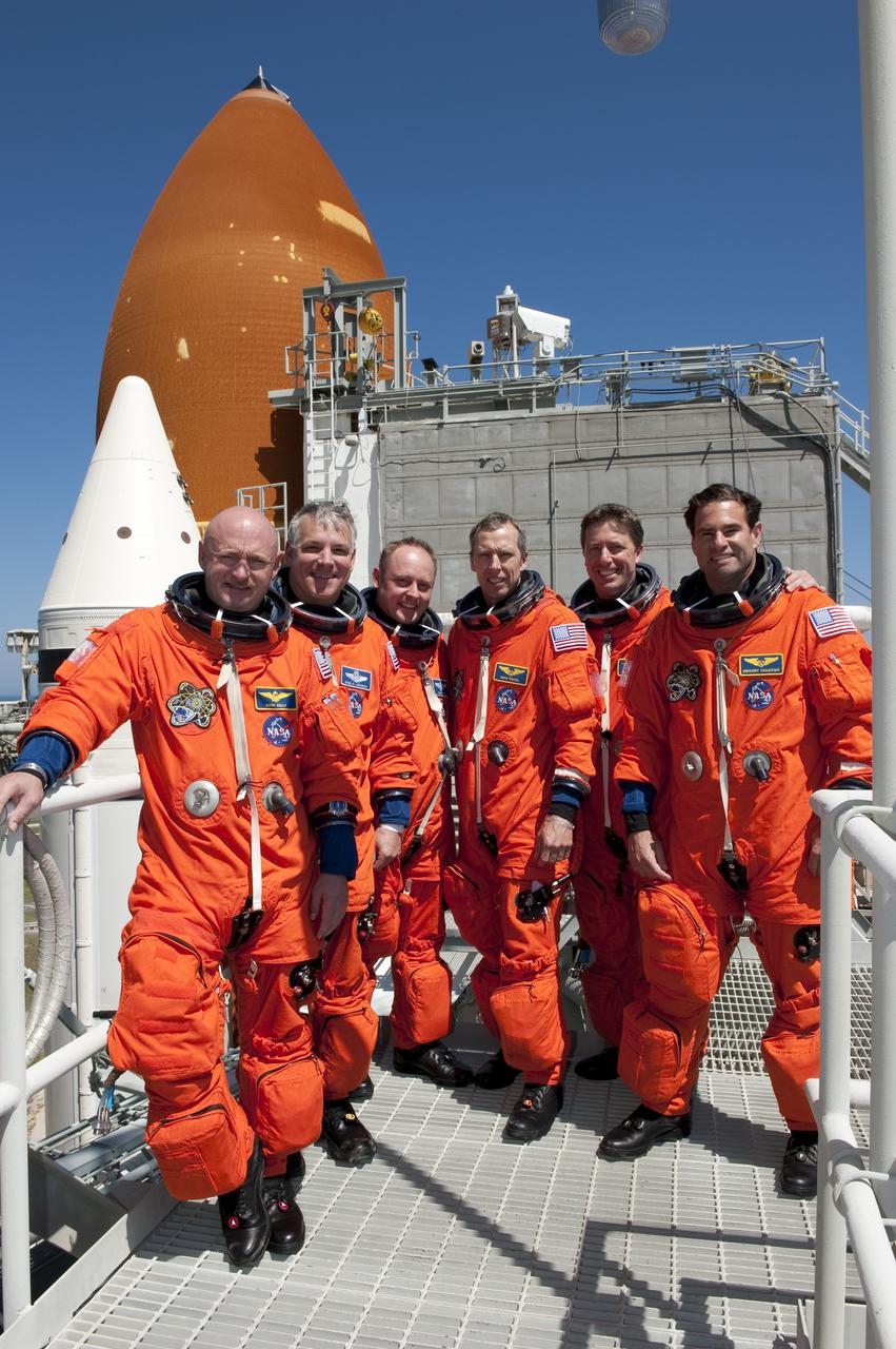 CAPE CANAVERAL, Fla. - At NASA's Kennedy Space Center in Florida, the STS-134 crew takes a break from a simulated launch countdown and simulated pad emergency to take a group photo on the 195-foot level of Launch Pad 39A. From left are, Commander Mark Kelly, Pilot Greg H. Johnson, and Mission Specialists Michael Fincke, Andrew Feustel, Roberto Vittori, with the European Space Agency, and Greg Chamitoff. The simulations are part of a week-long Terminal Countdown Demonstration Test (TCDT). Endeavour's six crew members are targeted to launch April 19 at 7:48 p.m. EDT. They will deliver the Express Logistics Carrier-3, Alpha Magnetic Spectrometer-2 (AMS), a high-pressure gas tank, additional spare parts for the Dextre robotic helper and micrometeoroid debris shields to the International Space Station. This will be the final spaceflight for Endeavour. For more information visit, www.nasa.gov/mission_pages/shuttle/shuttlemissions/sts134/index.html. Photo credit: NASA/Kim Shiflett
