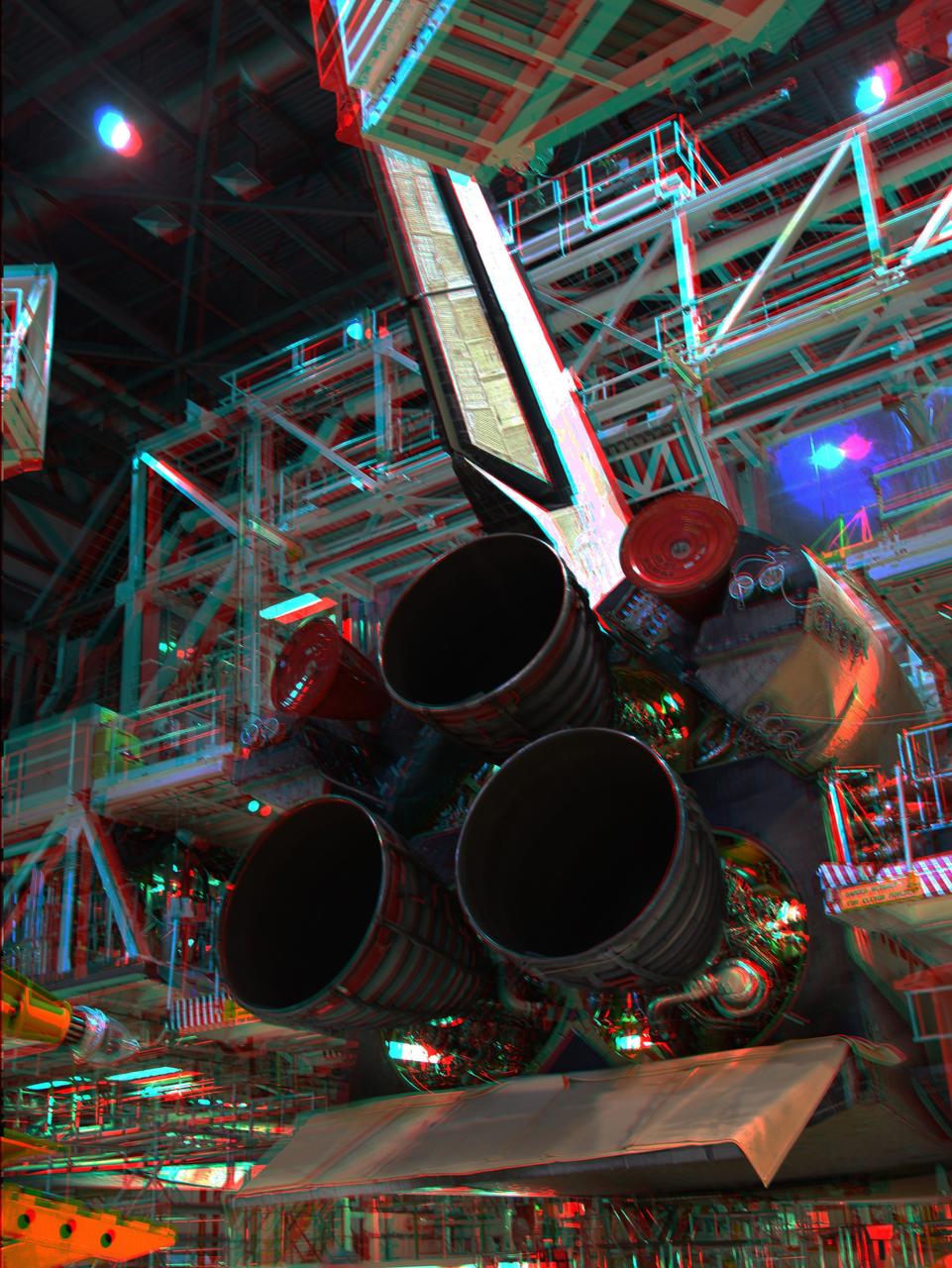 CAPE CANAVERAL, Fla. -- In Orbiter Processing Facility-2 at NASA's Kennedy Space Center in Florida, this 3-D image shows space shuttle Discovery's main engines before removeal for cleaning and inspection. The work is part of the spacecraft's transition and retirement processing and is expected to help rocket designers build next-generation spacecraft and prepare the shuttle for future public display. To view this image, use green and magenta 3-D glasses. Photo credit: NASA/Frankie Martin