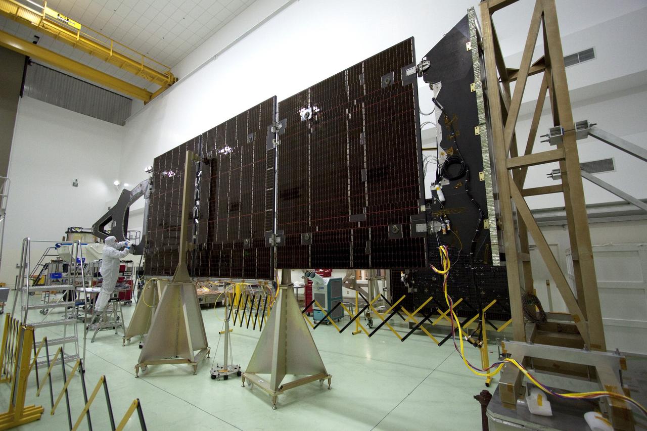 CAPE CANAVERAL, Fla. -- Technicians in the Astrotech payload processing facility in Titusville, Fla., install insulating blankets around the magnetometer boom. The boom structure is attached to Juno's solar array #1 that will help power the NASA spacecraft on its mission to Jupiter.        Juno is scheduled to launch aboard an Atlas V rocket from Cape Canaveral, Fla., on Aug. 5, 2011, reaching Jupiter in July 2016. The spacecraft will orbit the giant planet more than 30 times, skimming to within 3,000 miles above its cloud tops, for about one year. With its suite of science instruments, the spacecraft will investigate the existence of a solid planetary core, map Jupiter's intense magnetic field, measure the amount of water and ammonia in the deep atmosphere, and observe the planet's auroras. For more information visit, www.nasa.gov/juno. Photo credit: NASA/Jack Pfaller