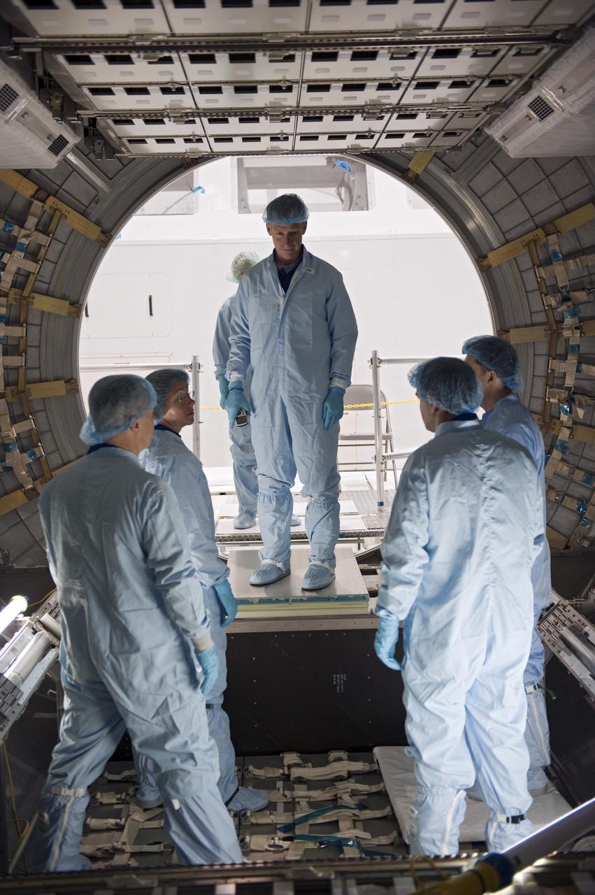CAPE CANAVERAL, Fla. -- In the Space Station Processing Facility at NASA's Kennedy Space Center in Florida, the STS-135 crew inspects the Raffaello multi-purpose logistics module with the carrier's technician. From left are Pilot Doug Hurley, Mission Specialist Sandy Magnus, Commander Chris Ferguson (upper level), a carrier technician and Mission Specialist Rex Walheim.  The four-member crew is at Kennedy participating in the Crew Equipment Interface Test (CEIT), which gives them an opportunity for hands-on training with tools they'll use in space and familiarization of the payload they'll deliver to the International Space Station.                   Shuttle Atlantis is being prepared for the STS-135 mission, which will deliver the Raffaello module packed with supplies and spare parts to the station. Atlantis is targeted to launch June 28, and will be the last shuttle flight for the Space Shuttle Program. For more information visit, http://www.nasa.gov/mission_pages/shuttle/shuttlemissions/sts135/index.html. Photo credit: NASA/Kim Shiflett
