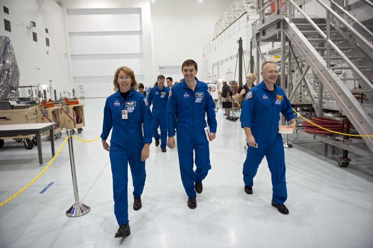 CAPE CANAVERAL, Fla. -- In the Space Station Processing Facility at NASA's Kennedy Space Center in Florida, the STS-135 crew members enjoy a light moment while they inspect the equipment they'll work with while in space. From left are Mission Specialists Sandy Magnus and Rex Walheim; Pilot Doug Hurley and Commander Chris Ferguson (rear). The four-member crew is at Kennedy participating in the Crew Equipment Interface Test (CEIT), which gives them an opportunity for hands-on training with tools they'll use in space and familiarization of the payload they'll deliver to the International Space Station.        Shuttle Atlantis is being prepared for the STS-135 mission, which will deliver the Raffaello multi-purpose logistics module packed with supplies and spare parts to the station. Atlantis is targeted to launch June 28, and will be the last shuttle flight for the Space Shuttle Program. For more information visit, http://www.nasa.gov/mission_pages/shuttle/shuttlemissions/sts135/index.html. Photo credit: NASA/Kim Shiflett
