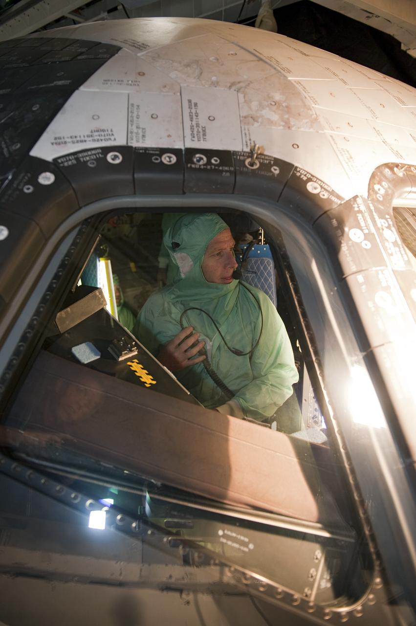 CAPE CANAVERAL, Fla. -- In Orbiter Processing Facility-1 at NASA's Kennedy Space Center in Florida, STS-135 Commander Chris Ferguson checks out shuttle Atlantis' cockpit. The four-member crew is at Kennedy to participate in the Crew Equipment Interface Test (CEIT), which gives them an opportunity for hands-on training with the tools and equipment they'll use and familiarization of the payload they'll deliver to the International Space Station.      Atlantis is being prepared for the STS-135 mission, which will deliver Raffaello multi-purpose logistics module packed with supplies and spare parts to the station. Atlantis is targeted to launch June 28, and will be the last shuttle flight for the Space Shuttle Program. Photo credit: NASA/Kim Shiflett
