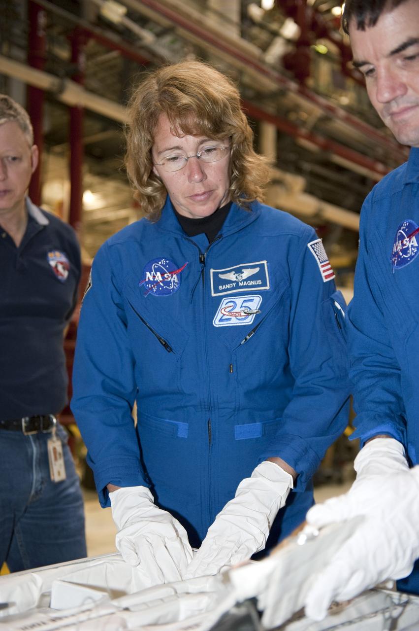 CAPE CANAVERAL, Fla. -- In Orbiter Processing Facility-1 at NASA's Kennedy Space Center in Florida, STS-135 Mission Specialists Sandy Magnus and Rex Walheim check out equipment they'll work with on their upcoming mission. The four-member crew is at Kennedy participating in the Crew Equipment Interface Test (CEIT), which gives them an opportunity for hands-on training with the tools and equipment they'll use and familiarization of shuttle Atlantis' payload they'll deliver to the International Space Station.          Atlantis is being prepared for the STS-135 mission, which will deliver Raffaello multi-purpose logistics module packed with supplies and spare parts to the station. Atlantis is targeted to launch June 28, and will be the last shuttle flight for the Space Shuttle Program. Photo credit: NASA/Kim Shiflett
