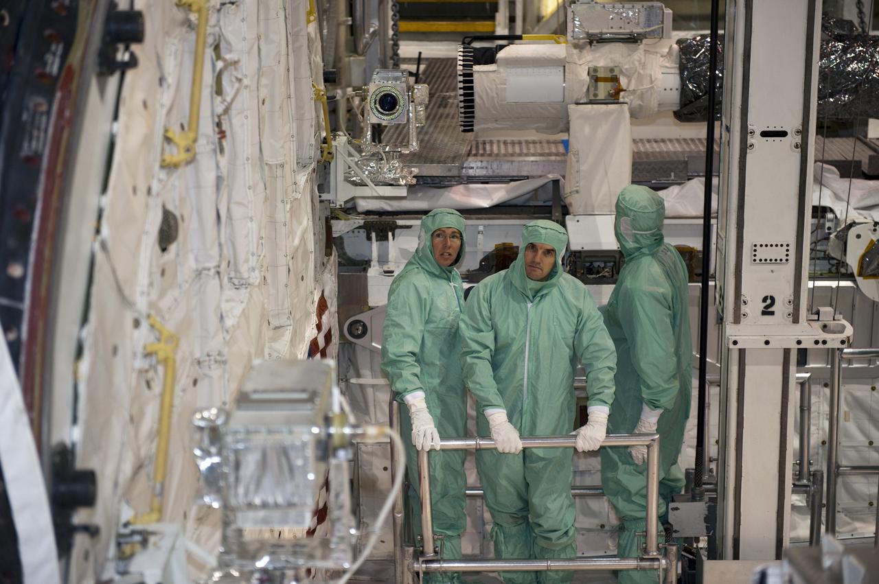 CAPE CANAVERAL, Fla. -- In Orbiter Processing Facility-1 at NASA's Kennedy Space Center in Florida, STS-135 Mission Specialists Sandy Magnus and Rex Walheim, along with Pilot Doug Hurley (turned away from the camera), inspect shuttle Atlantis' payload bay. The four-member crew is at Kennedy to participate in the Crew Equipment Interface Test (CEIT), which gives them an opportunity for hands-on training with the tools and equipment they'll use in space and familiarization of the payload they'll deliver to the International Space Station.      Atlantis is being prepared for the STS-135 mission, which will deliver Raffaello multi-purpose logistics module packed with supplies and spare parts to the station. Atlantis is targeted to launch June 28, and will be the last shuttle flight for the Space Shuttle Program. Photo credit: NASA/Kim Shiflett
