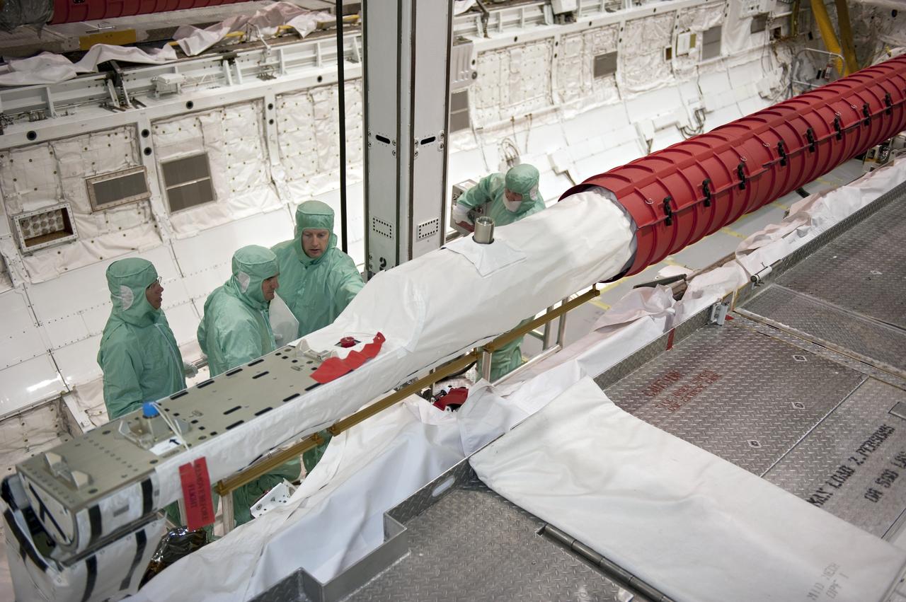 CAPE CANAVERAL, Fla. -- In Orbiter Processing Facility-1 at NASA's Kennedy Space Center in Florida, the STS-135 crew inspect shuttle Atlantis' payload bay. From left are Mission Specialists Sandy Magnus and Rex Walheim; Pilot Doug Hurley and Commander Chris Ferguson. The four-member crew is at Kennedy to participate in the Crew Equipment Interface Test (CEIT), which gives them an opportunity for hands-on training with the tools and equipment they'll use in space and familiarization of the payload they'll deliver to the International Space Station.      Atlantis is being prepared for the STS-135 mission, which will deliver Raffaello multi-purpose logistics module packed with supplies and spare parts to the station. Atlantis is targeted to launch June 28, and will be the last shuttle flight for the Space Shuttle Program. Photo credit: NASA/Kim Shiflett