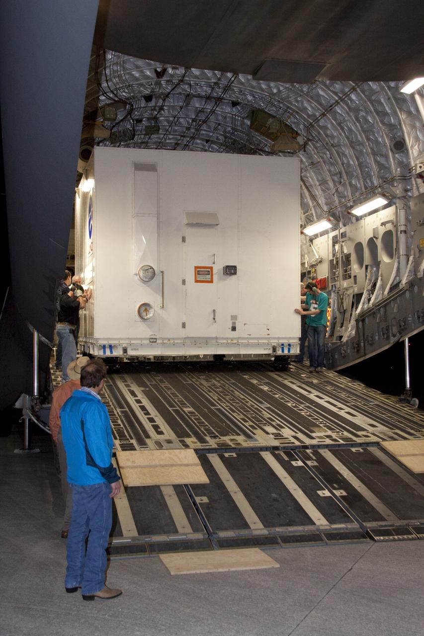 CAPE CANAVERAL, Fla. -- Workers guide the container holding NASA's Juno spacecraft down the ramp of an Air Force C-17 jet at Kennedy Space Center's Shuttle Landing Facility in Florida. Juno was shipped from Lockheed Martin Space Systems in Denver and will be transported to Astrotech's payload processing facility in Titusville, Fla. to begin final preparations for launch.              The solar-powered spacecraft will orbit Jupiter's poles 33 times to find out more about the gas giant's origins, structure, atmosphere and magnetosphere and investigate the existence of a solid planetary core. Juno is scheduled to launch aboard an Atlas V rocket from Cape Canaveral, Fla. Aug. 5. For more information visit, www.nasa.gov/juno. Photo credit: NASA/Jack Pfaller