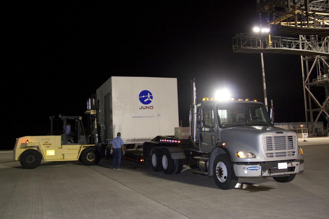 CAPE CANAVERAL, Fla. -- At the Shuttle Landing Facility at NASA's Kennedy Space Center in Florida, workers move the container holding NASA's Juno spacecraft onto a truck that will transport it to Astrotech's payload processing facility in Titusville, Fla. to begin final preparations for launch.                      The solar-powered spacecraft will orbit Jupiter's poles 33 times to find out more about the gas giant's origins, structure, atmosphere and magnetosphere and investigate the existence of a solid planetary core. Juno is scheduled to launch aboard an Atlas V rocket from Cape Canaveral, Fla. Aug. 5. For more information visit, www.nasa.gov/juno. Photo credit: NASA/Jack Pfaller