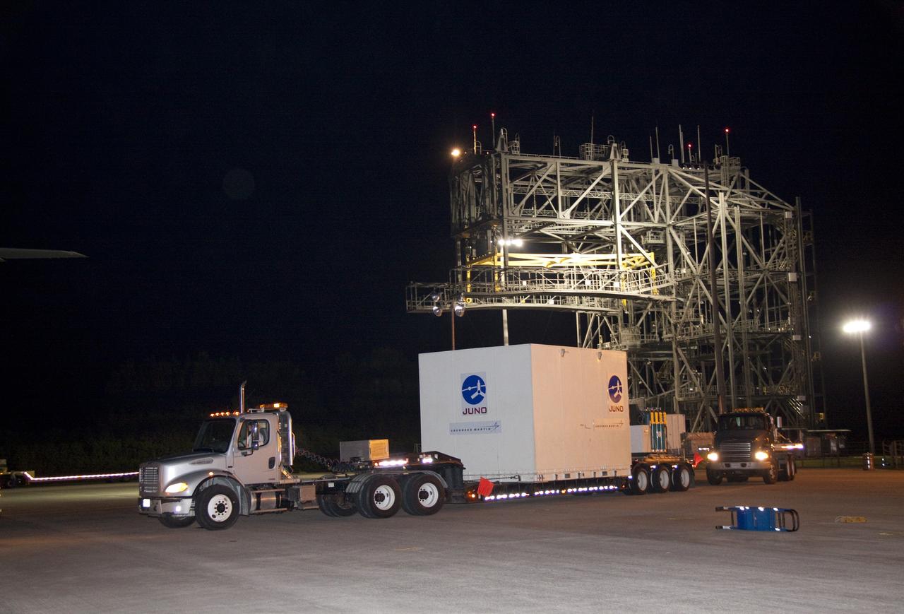 CAPE CANAVERAL, Fla. -- At the Shuttle Landing Facility at NASA's Kennedy Space Center in Florida, the containers holding NASA's Juno spacecraft and its high-gain antenna are secured on a truck that will transport it to Astrotech's payload processing facility in Titusville, Fla. to begin final preparations for launch.                    The solar-powered spacecraft will orbit Jupiter's poles 33 times to find out more about the gas giant's origins, structure, atmosphere and magnetosphere and investigate the existence of a solid planetary core. Juno is scheduled to launch aboard an Atlas V rocket from Cape Canaveral, Fla. Aug. 5. For more information visit, www.nasa.gov/juno. Photo credit: NASA/Jack Pfaller