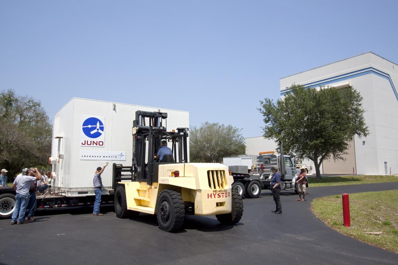 CAPE CANAVERAL, Fla. -- Workers use a Hyster forklift to move NASA's Juno spacecraft from a transport into Astrotech's payload processing facility in Titusville, Fla. to begin final testing and preparations for launch.        The solar-powered spacecraft will orbit Jupiter's poles 33 times to find out more about the gas giant's origins, structure, atmosphere and magnetosphere and investigate the existence of a solid planetary core. Juno is scheduled to launch aboard an Atlas V rocket from Cape Canaveral, Fla. Aug. 5. For more information visit, www.nasa.gov/juno. Photo credit: NASA/Jack Pfaller    It will splash down into the Atlantic Ocean where the ship and its crew will recover it and tow it back through Port Canaveral for refurbishing for another launch. The STS-124 mission is the second of three flights launching components to complete the Japan Aerospace Exploration Agency's Kibo laboratory. The shuttle crew will install Kibo's large Japanese Pressurized Module and its remote manipulator system, or RMS. Photo credit: USA/Jeff Suter