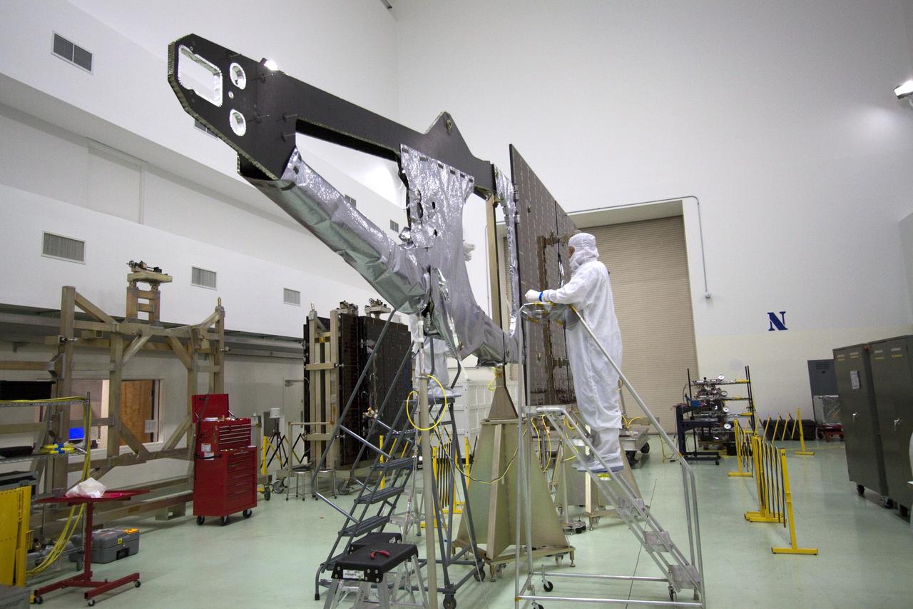 CAPE CANAVERAL, Fla. -- Technicians in the Astrotech payload processing facility in Titusville, Fla. install thermal insulation on NASA's Juno magnetometer boom. The boom structure is attached to Juno's solar array #1 that will help power the NASA spacecraft on its mission to Jupiter.      The solar-powered spacecraft will orbit Jupiter's poles 33 times to find out more about the gas giant's origins, structure, atmosphere and magnetosphere and investigate the existence of a solid planetary core. Juno is scheduled to launch aboard an Atlas V rocket from Cape Canaveral, Fla. Aug. 5. For more information visit, www.nasa.gov/juno. Photo credit: NASA/Jack Pfaller    It will splash down into the Atlantic Ocean where the ship and its crew will recover it and tow it back through Port Canaveral for refurbishing for another launch. The STS-124 mission is the second of three flights launching components to complete the Japan Aerospace Exploration Agency's Kibo laboratory. The shuttle crew will install Kibo's large Japanese Pressurized Module and its remote manipulator system, or RMS. Photo credit: USA/Jeff Suter