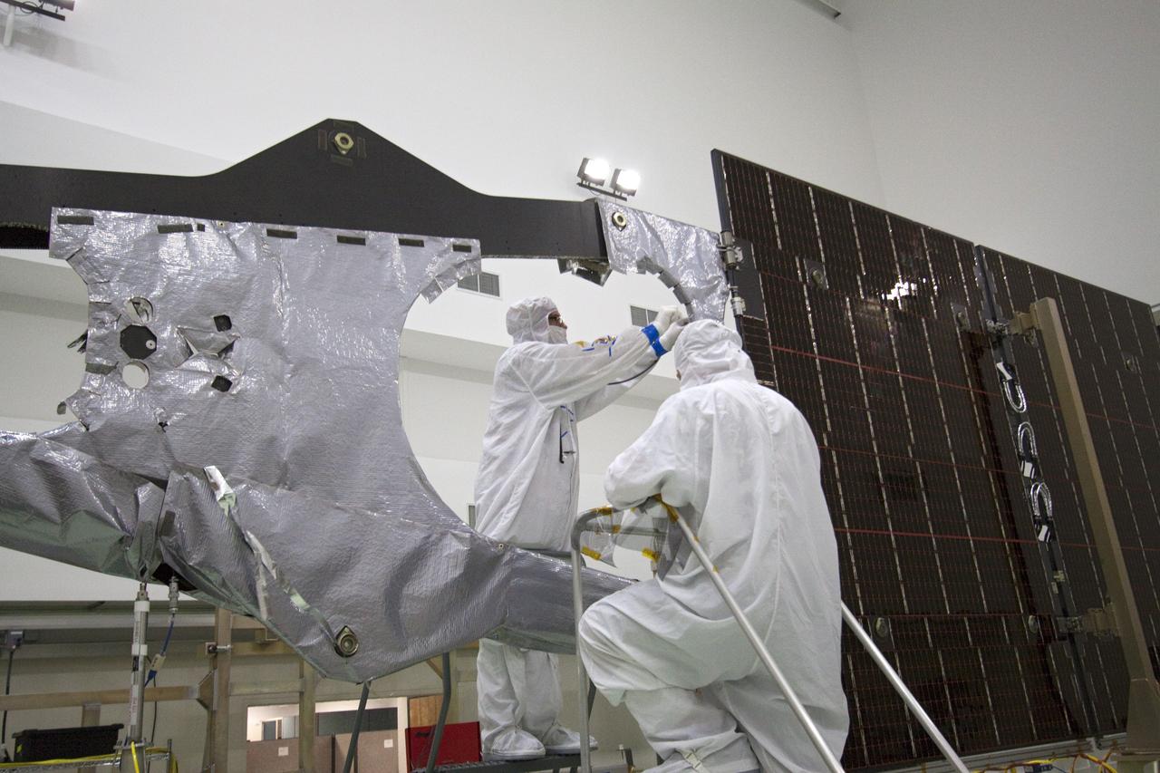 CAPE CANAVERAL, Fla. -- Technicians in the Astrotech payload processing facility in Titusville, Fla. install thermal insulation on NASA's Juno magnetometer boom. The boom structure is attached to Juno's solar array #1 that will help power the NASA spacecraft on its mission to Jupiter.      The solar-powered spacecraft will orbit Jupiter's poles 33 times to find out more about the gas giant's origins, structure, atmosphere and magnetosphere and investigate the existence of a solid planetary core. Juno is scheduled to launch aboard an Atlas V rocket from Cape Canaveral, Fla. Aug. 5. For more information visit, www.nasa.gov/juno. Photo credit: NASA/Jack Pfaller    It will splash down into the Atlantic Ocean where the ship and its crew will recover it and tow it back through Port Canaveral for refurbishing for another launch. The STS-124 mission is the second of three flights launching components to complete the Japan Aerospace Exploration Agency's Kibo laboratory. The shuttle crew will install Kibo's large Japanese Pressurized Module and its remote manipulator system, or RMS. Photo credit: USA/Jeff Suter