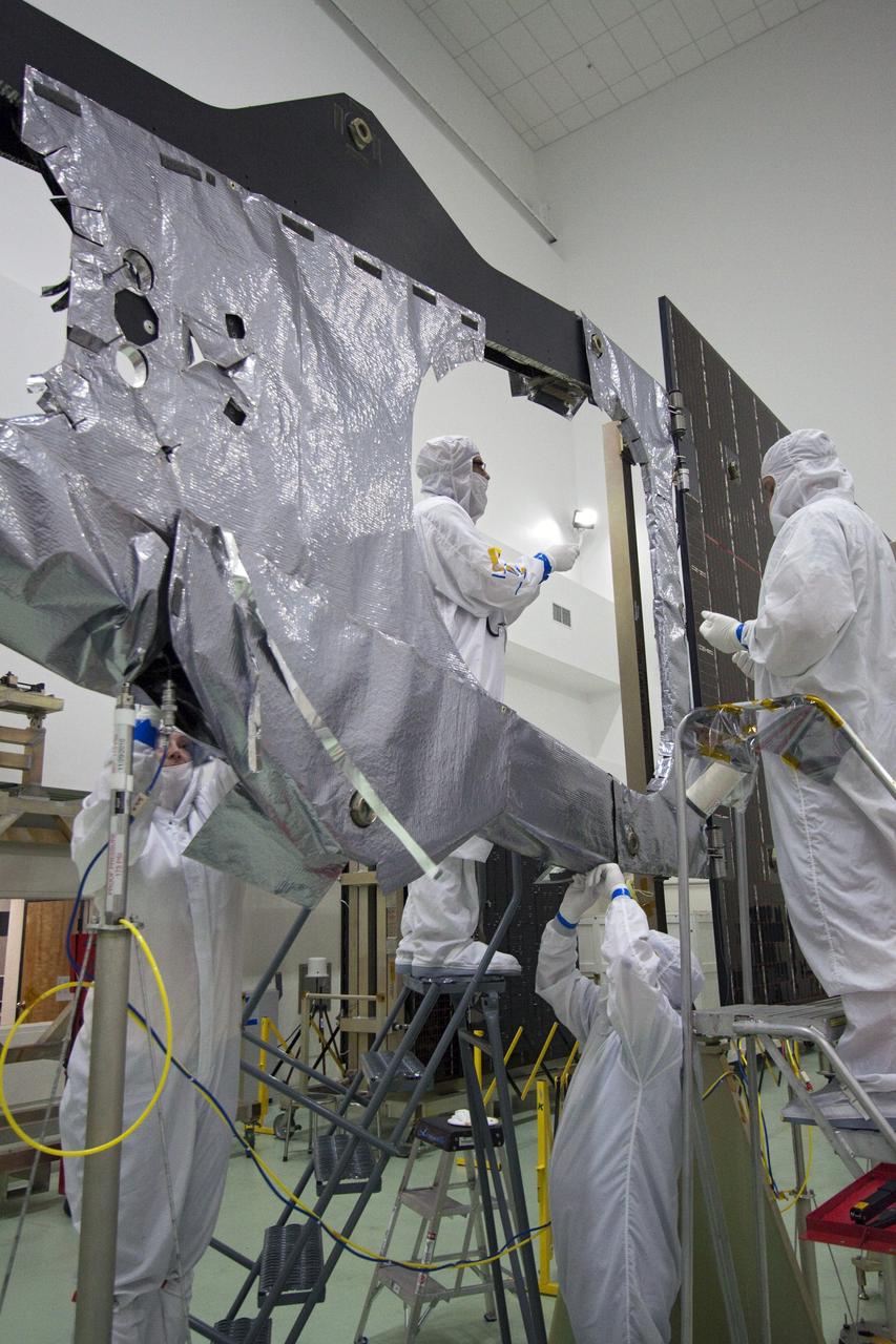 CAPE CANAVERAL, Fla. -- Technicians in the Astrotech payload processing facility in Titusville, Fla. install thermal insulation on NASA's Juno magnetometer boom. The boom structure is attached to Juno's solar array #1 that will help power the NASA spacecraft on its mission to Jupiter.      The solar-powered spacecraft will orbit Jupiter's poles 33 times to find out more about the gas giant's origins, structure, atmosphere and magnetosphere and investigate the existence of a solid planetary core. Juno is scheduled to launch aboard an Atlas V rocket from Cape Canaveral, Fla. Aug. 5. For more information visit, www.nasa.gov/juno. Photo credit: NASA/Jack Pfaller    It will splash down into the Atlantic Ocean where the ship and its crew will recover it and tow it back through Port Canaveral for refurbishing for another launch. The STS-124 mission is the second of three flights launching components to complete the Japan Aerospace Exploration Agency's Kibo laboratory. The shuttle crew will install Kibo's large Japanese Pressurized Module and its remote manipulator system, or RMS. Photo credit: USA/Jeff Suter