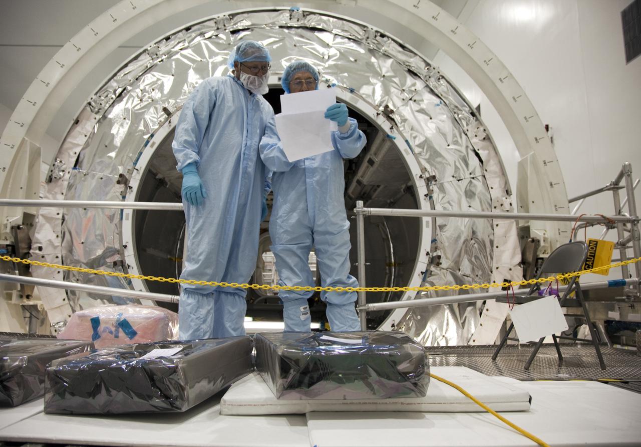 CAPE CANAVERAL, Fla. -- In the Space Station Processing Facility at NASA's Kennedy Space Center in Florida, technicians garbed in protective wear, commonly known as 'bunny suits,' check out the installation plans for the correct placement of the cargo inside the Raffaello multi-purpose logistics module for shuttle Atlantis' flight to the International Space Station.      Atlantis and its payload is being prepared for the STS-135 mission, which will deliver the Raffaello multi-purpose logistics module packed with supplies and spare parts to the station. Atlantis is targeted to launch June 28, and will be the last shuttle flight for the Space Shuttle Program. For more information visit, http://www.nasa.gov/mission_pages/shuttle/shuttlemissions/sts135/index.html. Photo credit: NASA/Frankie Martin