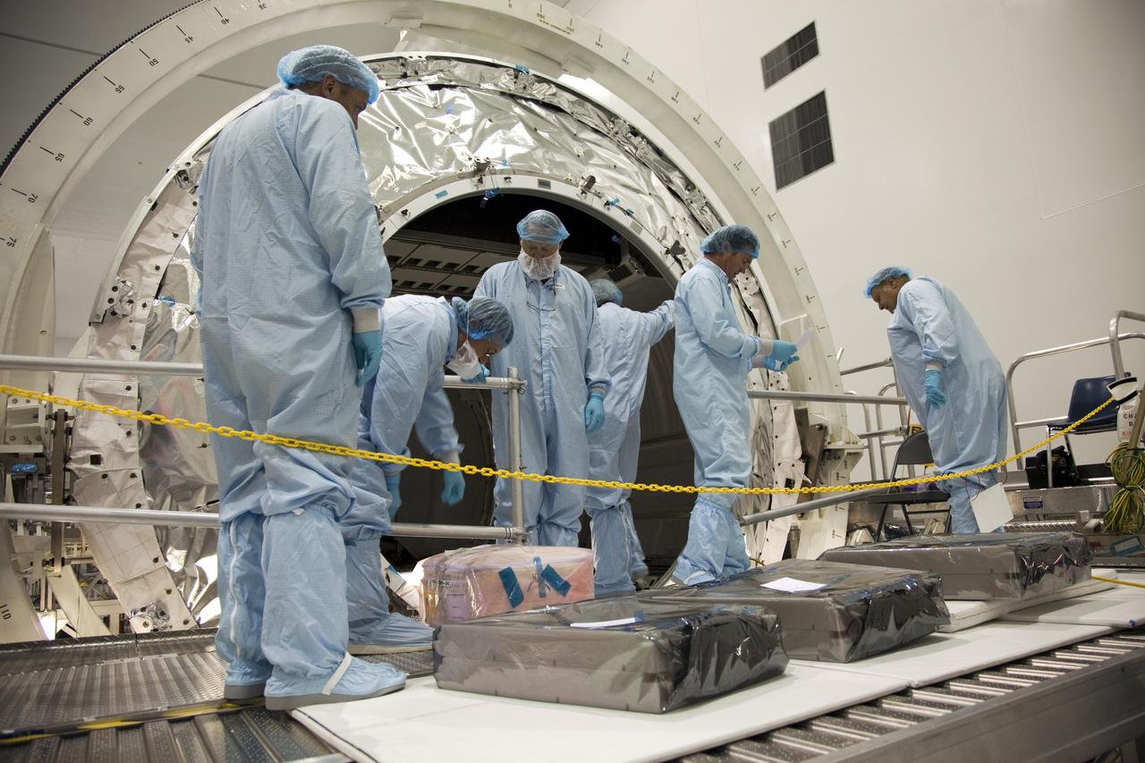 CAPE CANAVERAL, Fla. -- In the Space Station Processing Facility at NASA's Kennedy Space Center in Florida, technicians garbed in protective wear, commonly known as 'bunny suits,' install the cargo inside the Raffaello multi-purpose logistics module for shuttle Atlantis' flight to the International Space Station.      Atlantis and its payload is being prepared for the STS-135 mission, which will deliver the Raffaello multi-purpose logistics module packed with supplies and spare parts to the station. Atlantis is targeted to launch June 28, and will be the last shuttle flight for the Space Shuttle Program. For more information visit, http://www.nasa.gov/mission_pages/shuttle/shuttlemissions/sts135/index.html. Photo credit: NASA/Frankie Martin