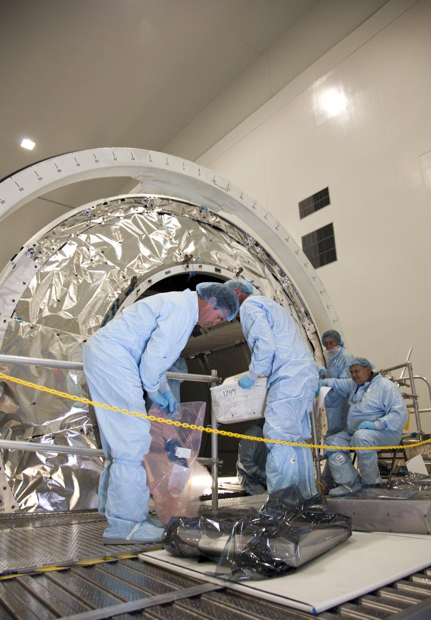 CAPE CANAVERAL, Fla. -- In the Space Station Processing Facility at NASA's Kennedy Space Center in Florida, technicians garbed in protective wear, commonly known as 'bunny suits,' install the cargo inside the Raffaello multi-purpose logistics module  for shuttle Atlantis' flight to the International Space Station.          Atlantis and its payload is being prepared for the STS-135 mission, which will deliver the Raffaello multi-purpose logistics module packed with supplies and spare parts to the station. Atlantis is targeted to launch June 28, and will be the last shuttle flight for the Space Shuttle Program. For more information visit, http://www.nasa.gov/mission_pages/shuttle/shuttlemissions/sts135/index.html. Photo credit: NASA/Frankie Martin