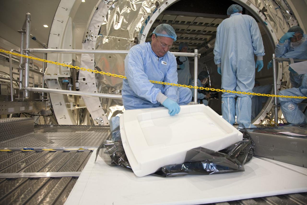 CAPE CANAVERAL, Fla. -- In the Space Station Processing Facility at NASA's Kennedy Space Center in Florida, a technician, garbed in protective wear, commonly known as a 'bunny suit,' inspects a piece of equipment prior to installation into the Raffaello multi-purpose logistics module for shuttle Atlantis' flight to the International Space Station.        Atlantis and its payload is being prepared for the STS-135 mission, which will deliver the Raffaello multi-purpose logistics module packed with supplies and spare parts to the station. Atlantis is targeted to launch June 28, and will be the last shuttle flight for the Space Shuttle Program. For more information visit, http://www.nasa.gov/mission_pages/shuttle/shuttlemissions/sts135/index.html. Photo credit: NASA/Frankie Martin