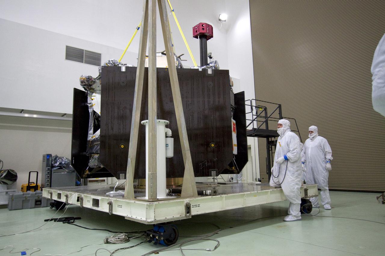 CAPE CANAVERAL, Fla. -- Technicians at Astrotech's payload processing facility in Titusville, Fla. attach an overhead crane to NASA's Juno spacecraft for its move to the rotation stand for testing.            The solar-powered spacecraft will orbit Jupiter's poles 33 times to find out more about the gas giant's origins, structure, atmosphere and magnetosphere and investigate the existence of a solid planetary core. Juno is scheduled to launch aboard an Atlas V rocket from Cape Canaveral, Fla. Aug. 5. For more information visit, www.nasa.gov/juno. Photo credit: NASA/Jack Pfaller