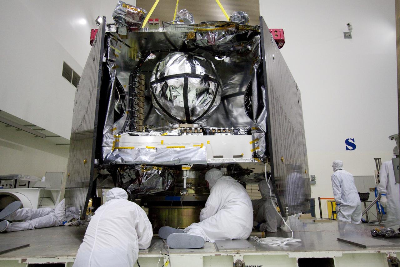 CAPE CANAVERAL, Fla. -- Technicians at Astrotech's payload processing facility in Titusville, Fla. prepare NASA's Juno spacecraft for its move to the rotation stand for testing.          The solar-powered spacecraft will orbit Jupiter's poles 33 times to find out more about the gas giant's origins, structure, atmosphere and magnetosphere and investigate the existence of a solid planetary core. Juno is scheduled to launch aboard an Atlas V rocket from Cape Canaveral, Fla. Aug. 5. For more information visit, www.nasa.gov/juno. Photo credit: NASA/Jack Pfaller