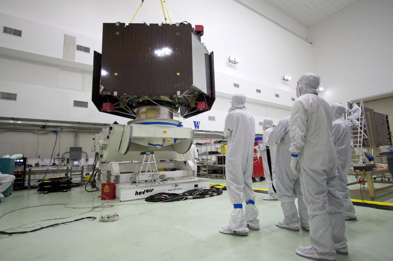 CAPE CANAVERAL, Fla. -- Technicians at Astrotech's payload processing facility in Titusville, Fla. guide NASA's Juno spacecraft, as it is lowered by overhead crane, onto the rotation stand for testing.            The solar-powered spacecraft will orbit Jupiter's poles 33 times to find out more about the gas giant's origins, structure, atmosphere and magnetosphere and investigate the existence of a solid planetary core. Juno is scheduled to launch aboard an Atlas V rocket from Cape Canaveral, Fla. Aug. 5. For more information visit, www.nasa.gov/juno. Photo credit: NASA/Jack Pfaller