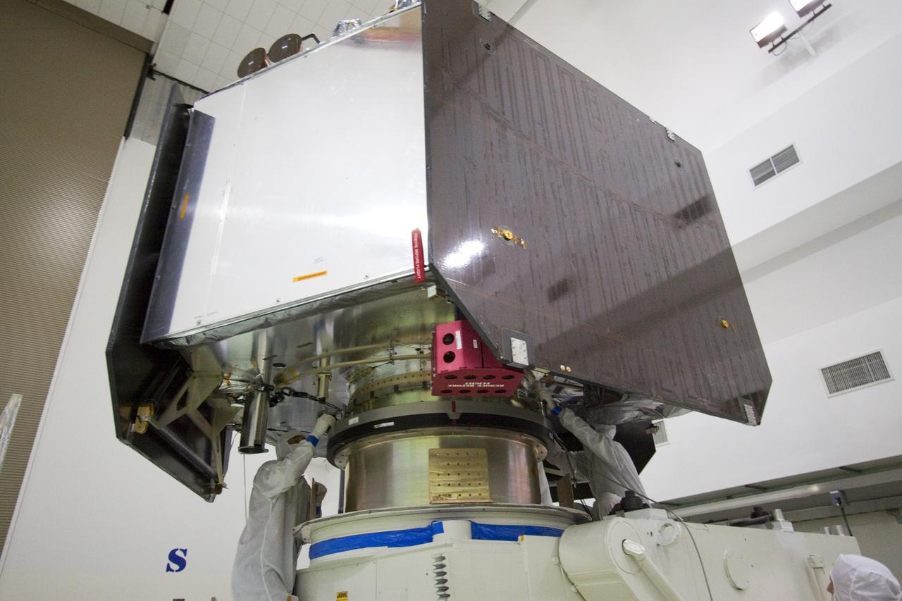 CAPE CANAVERAL, Fla. -- Technicians at Astrotech's payload processing facility in Titusville, Fla. secure NASA's Juno spacecraft to the rotation stand for testing.        The solar-powered spacecraft will orbit Jupiter's poles 33 times to find out more about the gas giant's origins, structure, atmosphere and magnetosphere and investigate the existence of a solid planetary core. Juno is scheduled to launch aboard an Atlas V rocket from Cape Canaveral, Fla. Aug. 5. For more information visit, www.nasa.gov/juno. Photo credit: NASA/Jack Pfaller