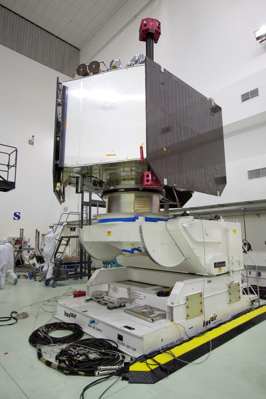 CAPE CANAVERAL, Fla. -- NASA's Juno spacecraft is secured to the rotation stand for testing in Astrotech's payload processing facility in Titusville, Fla.      The solar-powered spacecraft will orbit Jupiter's poles 33 times to find out more about the gas giant's origins, structure, atmosphere and magnetosphere and investigate the existence of a solid planetary core. Juno is scheduled to launch aboard an Atlas V rocket from Cape Canaveral, Fla. Aug. 5. For more information visit, www.nasa.gov/juno. Photo credit: NASA/Jack Pfaller