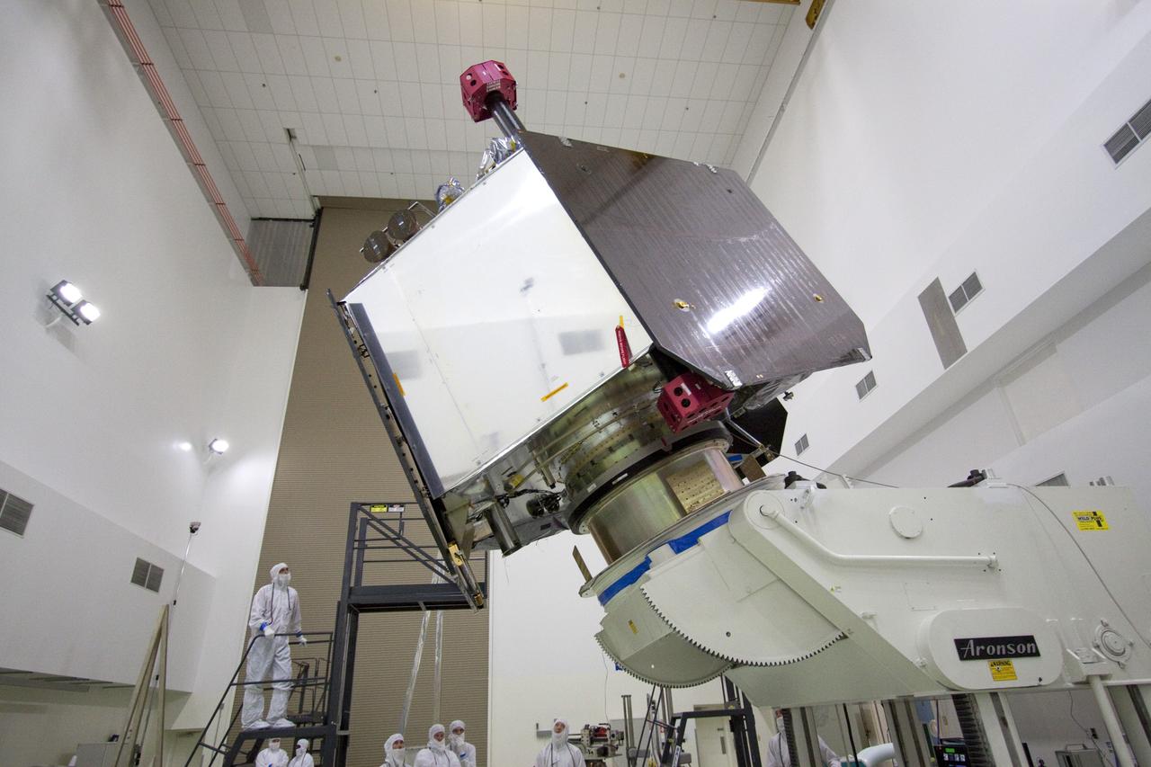 CAPE CANAVERAL, Fla. -- Technicians at Astrotech's payload processing facility in Titusville, Fla. watch vigilantly as NASA's Juno spacecraft is tested for center of gravity, weighing and balancing on the rotation stand.            The solar-powered spacecraft will orbit Jupiter's poles 33 times to find out more about the gas giant's origins, structure, atmosphere and magnetosphere and investigate the existence of a solid planetary core. Juno is scheduled to launch aboard an Atlas V rocket from Cape Canaveral, Fla. Aug. 5. For more information visit, www.nasa.gov/juno. Photo credit: NASA/Jack Pfaller