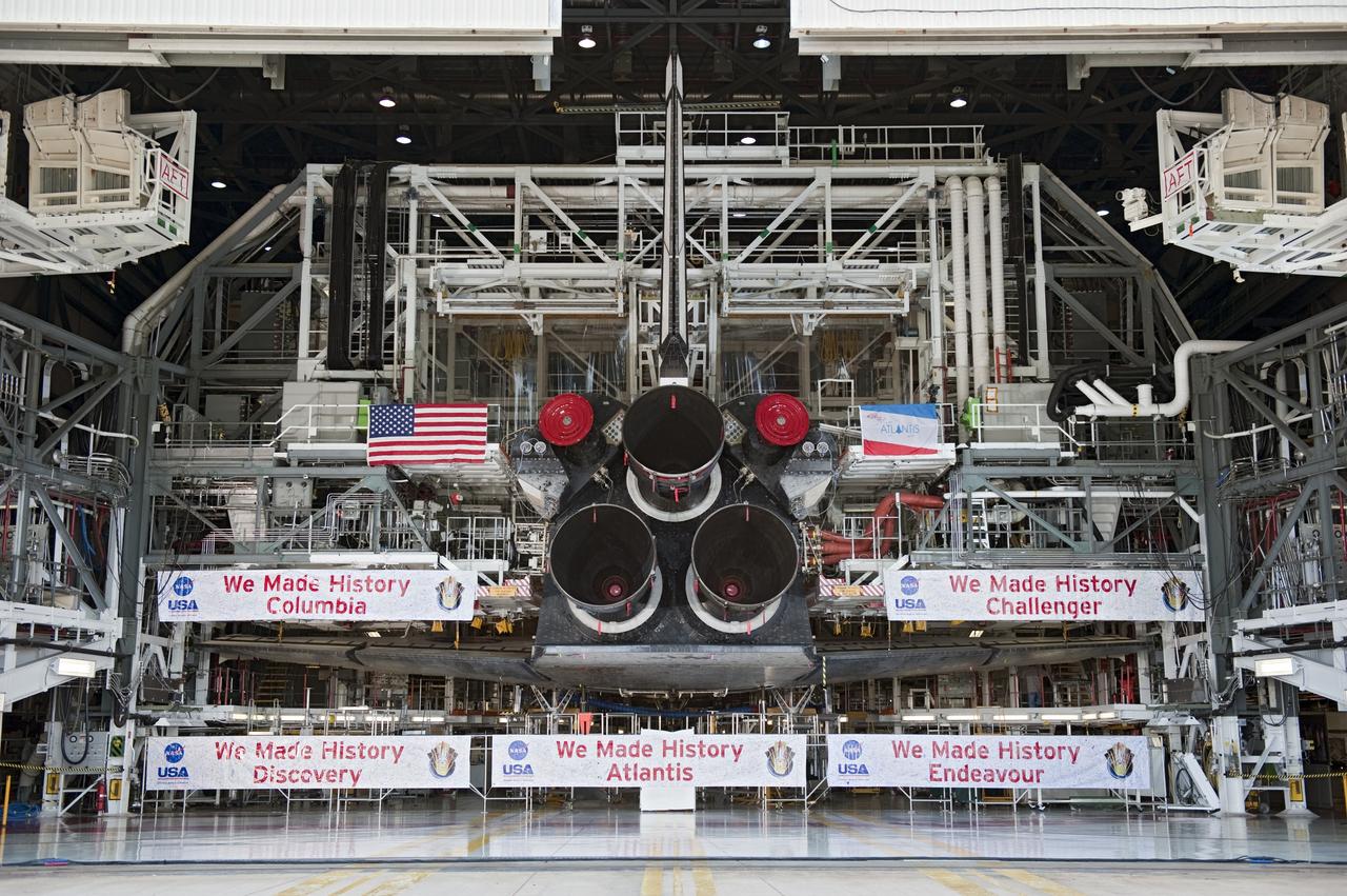 CAPE CANAVERAL, Fla. -- Shuttle Atlantis' three main engines take center stage to the banners commemorating the orbiters that served the Space Shuttle Program.         In a ceremony held in front of Orbiter Processing Facility-1 at NASA's Kennedy Space Center in Florida, NASA Administrator Charles Bolden announced the facilities where four shuttle orbiters will be displayed permanently at the conclusion of the Space Shuttle Program. Shuttle Enterprise, the first orbiter built, will move from the Smithsonian's National Air and Space Museum Steven F. Udvar-Hazy Center in Virginia to the Intrepid Sea, Air & Space Museum in New York. The Udvar-Hazy Center will become the new home for shuttle Discovery, which retired after completing its 39th mission in March. Shuttle Endeavour, which is preparing for its final flight at the end of the month, will go to the California Science Center in Los Angeles. Atlantis, which will fly the last planned shuttle mission in June, will be displayed at the Kennedy Space Center Visitor Complex in Florida. Later, employees, their families and friends, will celebrate the 30th anniversary of the first shuttle launch at the visitor complex.  Photo credit: NASA/Kim Shiflett