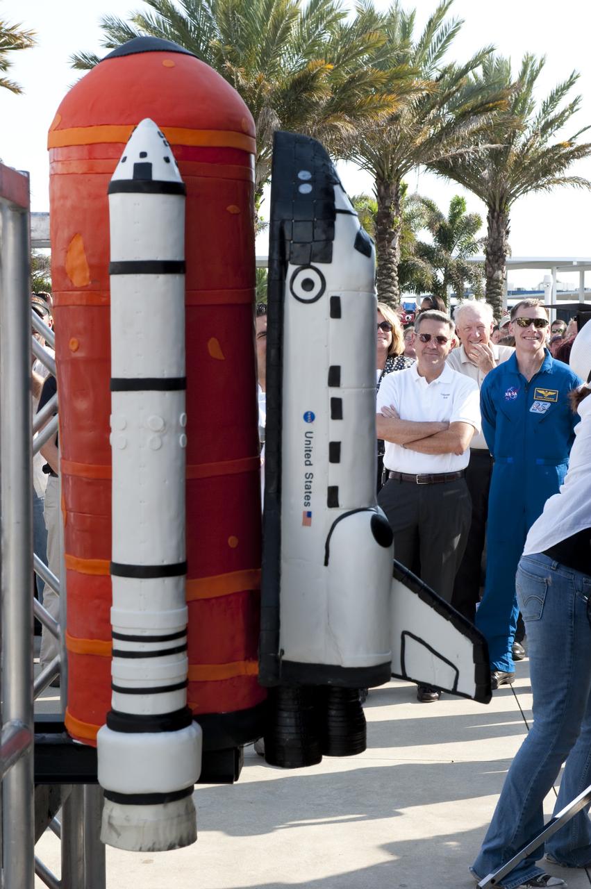 CAPE CANAVERAL, Fla. -- At NASA's Kennedy Space Center Visitor Complex in Florida, Kennedy Center Director Bob Cabana, NASA Astronaut and STS-135 Commander Chris Ferguson and invited guests admire a cake formed in the shape of a space shuttle. The cake was created by Buddy Valastro from Carlo's Bakery (Cake Boss) who was inspired to pay tribute to the workforce and the 30th anniversary of NASA's Space Shuttle Program. The celebration followed an announcement by NASA Administrator Charles Bolden where the four orbiters will be placed for permanent display after retirement. Photo credit: NASA/Kim Shiflett