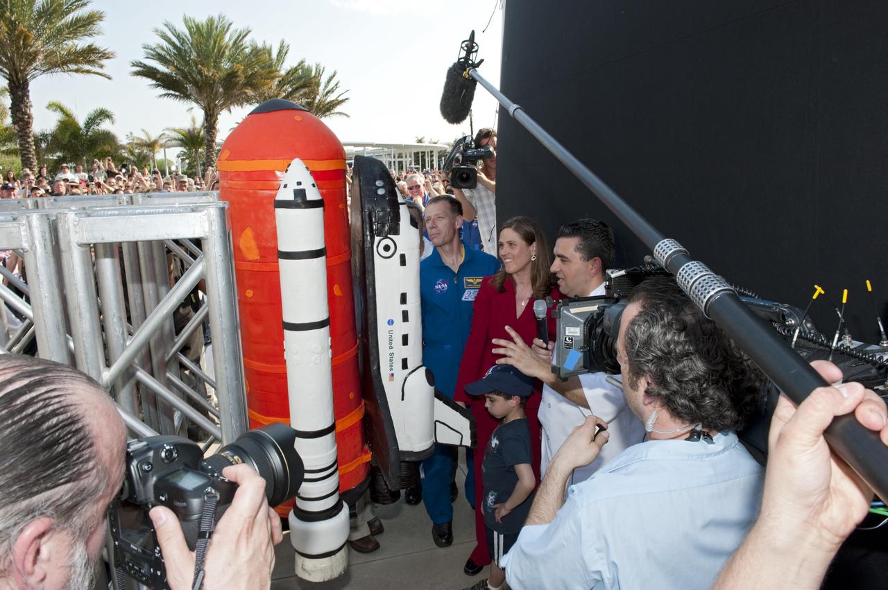 CAPE CANAVERAL, Fla. -- At NASA's Kennedy Space Center Visitor Complex in Florida, Buddy Valastro from Carlo's Bakery (Cake Boss) speaks to the crowd about his tribute to the workforce and NASA's successful Space Shuttle Program in the form of a space shuttle cake celebrating the Program's 30th anniversary. Alongside Valastro is Rita Willcoxon, Launch Vehicle Processing director and NASA Astronaut and STS-135 Commander Chris Ferguson. The celebration followed an announcement by NASA Administrator Charles Bolden where the four orbiters will be placed for permanent display after retirement. Photo credit: NASA/Kim Shiflett