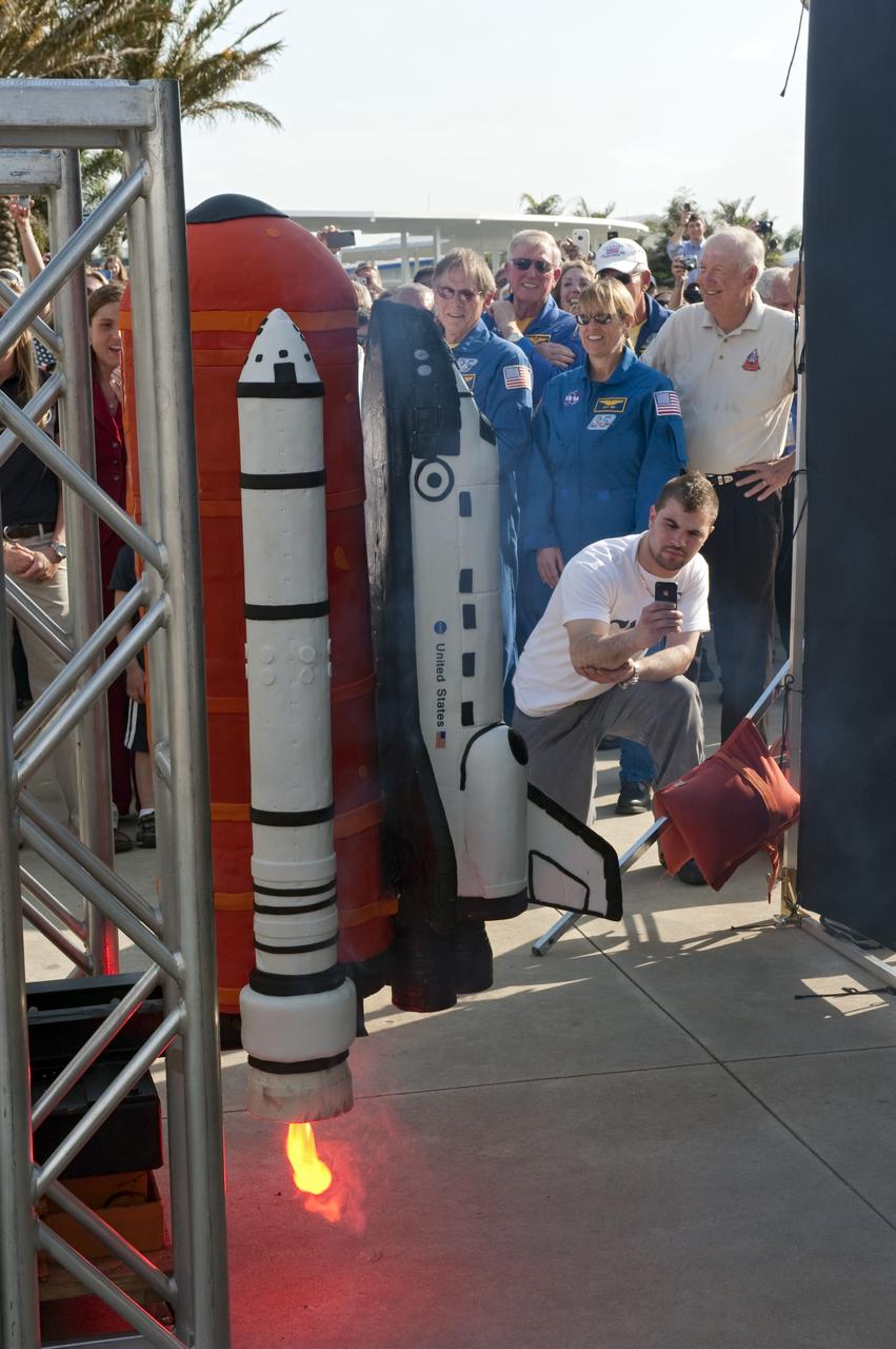 CAPE CANAVERAL, Fla. -- At NASA's Kennedy Space Center Visitor Complex in Florida, invited guests admire a cake formed in the shape of a space shuttle. The cake was created by Buddy Valastro from Carlo's Bakery (Cake Boss) who was inspired to pay tribute to the workforce and the 30th anniversary of NASA's Space Shuttle Program. The celebration followed an announcement by NASA Administrator Charles Bolden where the four orbiters will be placed for permanent display after retirement. Photo credit: NASA/Kim Shiflett
