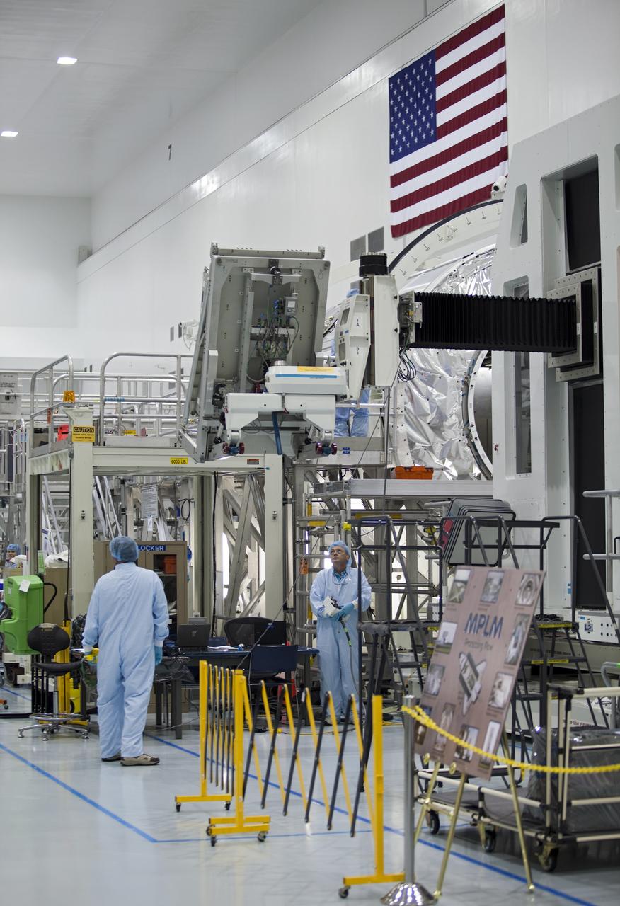 CAPE CANAVERAL, Fla. -- In the Space Station Processing Facility at NASA's Kennedy Space Center in Florida, technicians monitor the progress of cargo as it is being prepared for installation inside the Raffaello multi-purpose logistics module for shuttle Atlantis' flight to the International Space Station.      Atlantis and its payload is being prepared for the STS-135 mission, which will deliver the Raffaello multi-purpose logistics module packed with supplies and spare parts to the station. Atlantis is targeted to launch June 28, and will be the last shuttle flight for the Space Shuttle Program. For more information visit, http://www.nasa.gov/mission_pages/shuttle/shuttlemissions/sts135/index.html. Photo credit: NASA/Frankie Martin