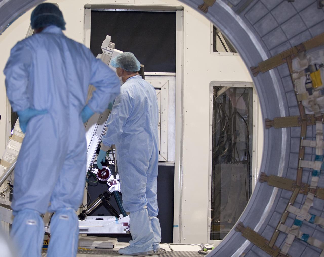 CAPE CANAVERAL, Fla. -- In the Space Station Processing Facility at NASA's Kennedy Space Center in Florida, technicians monitor the progress of cargo as it is being prepared for installation inside the Raffaello multi-purpose logistics module for shuttle Atlantis' flight to the International Space Station.    Atlantis and its payload is being prepared for the STS-135 mission, which will deliver the Raffaello multi-purpose logistics module packed with supplies and spare parts to the station. Atlantis is targeted to launch June 28, and will be the last shuttle flight for the Space Shuttle Program. For more information visit, http://www.nasa.gov/mission_pages/shuttle/shuttlemissions/sts135/index.html. Photo credit: NASA/Frankie Martin
