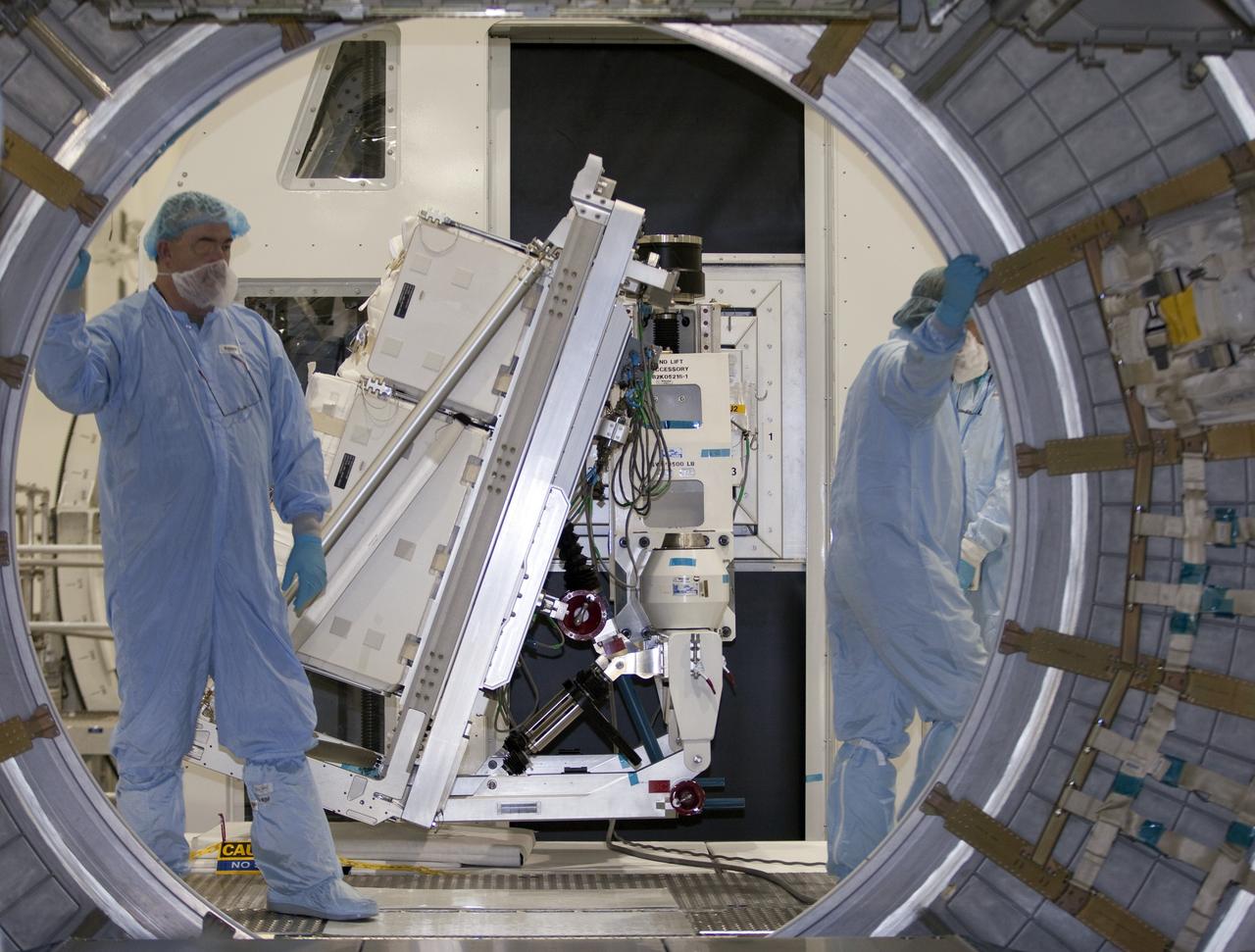CAPE CANAVERAL, Fla. -- In the Space Station Processing Facility at NASA's Kennedy Space Center in Florida, technicians are preparing to install cargo for installation inside the Raffaello multi-purpose logistics module for shuttle Atlantis' flight to the International Space Station.          Atlantis and its payload is being prepared for the STS-135 mission, which will deliver the Raffaello multi-purpose logistics module packed with supplies and spare parts to the station. Atlantis is targeted to launch June 28, and will be the last shuttle flight for the Space Shuttle Program. For more information visit, http://www.nasa.gov/mission_pages/shuttle/shuttlemissions/sts135/index.html. Photo credit: NASA/Frankie Martin