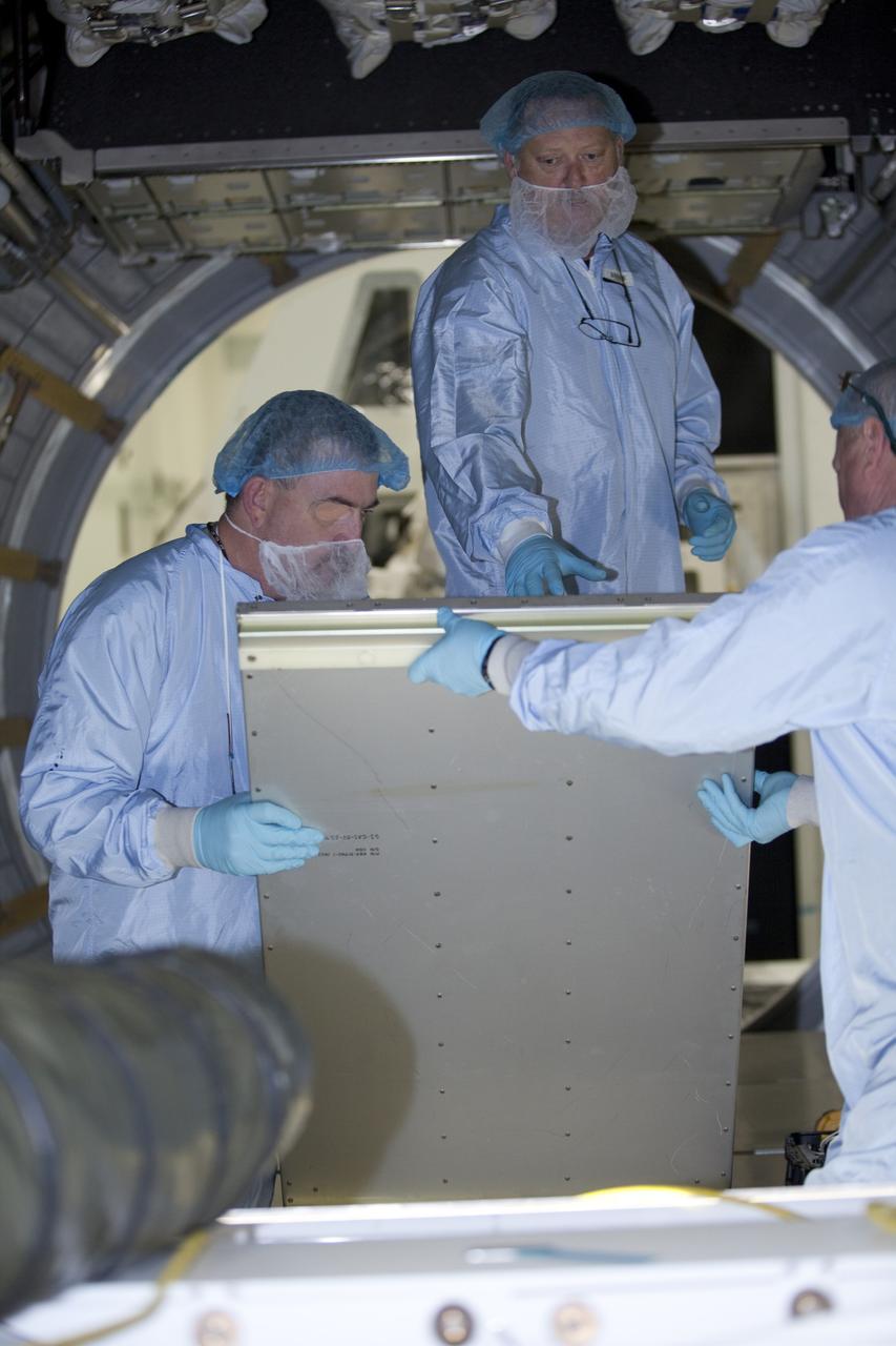 CAPE CANAVERAL, Fla. -- In the Space Station Processing Facility at NASA's Kennedy Space Center in Florida, technicians install cargo inside the Raffaello multi-purpose logistics module for shuttle Atlantis' flight to the International Space Station.      Atlantis and its payload is being prepared for the STS-135 mission, which will deliver the Raffaello multi-purpose logistics module packed with supplies and spare parts to the station. Atlantis is targeted to launch June 28, and will be the last shuttle flight for the Space Shuttle Program. For more information visit, http://www.nasa.gov/mission_pages/shuttle/shuttlemissions/sts135/index.html. Photo credit: NASA/Frankie Martin