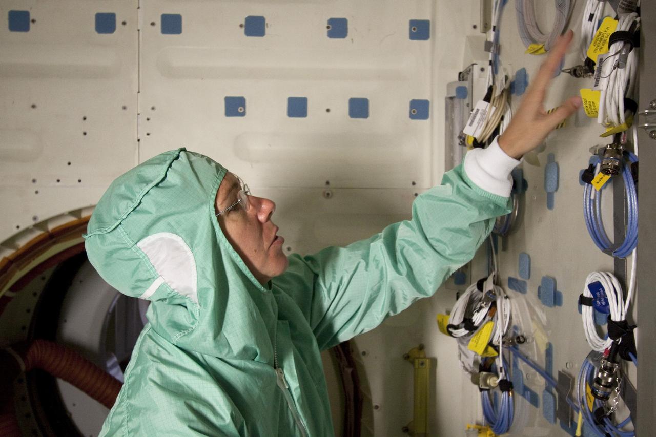 CAPE CANAVERAL, Fla. -- In the Space Station Processing Facility at NASA's Kennedy Space Center in Florida, STS-135 Mission Specialist Sandy Magnus is inspecting the mid-deck of shuttle Atlantis. The four-member crew is at Kennedy participating in the Crew Equipment Interface Test (CEIT), which gives them an opportunity for hands-on training with the spacecraft and familiarization of the payload they'll deliver to the International Space Station.         Atlantis and its payload is being prepared for the STS-135 mission, which will deliver the Raffaello multi-purpose logistics module packed with supplies and spare parts to the station. Atlantis is targeted to launch June 28, and will be the last shuttle flight for the Space Shuttle Program. For more information visit, http://www.nasa.gov/mission_pages/shuttle/shuttlemissions/sts135/index.html. Photo credit: NASA/Frankie Martin