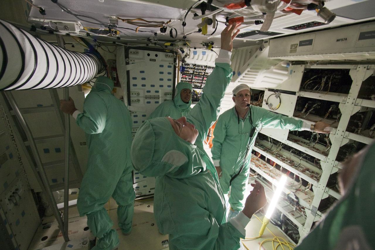 CAPE CANAVERAL, Fla. -- In the Space Station Processing Facility at NASA's Kennedy Space Center in Florida, STS-135 Mission Specialist Sandy Magnus along with technicians are inspecting the mid-deck of shuttle Atlantis. The four-member crew is at Kennedy participating in the Crew Equipment Interface Test (CEIT), which gives them an opportunity for hands-on training with the spacecraft and familiarization of the payload they'll deliver to the International Space Station.       Atlantis and its payload is being prepared for the STS-135 mission, which will deliver the Raffaello multi-purpose logistics module packed with supplies and spare parts to the station. Atlantis is targeted to launch June 28, and will be the last shuttle flight for the Space Shuttle Program. For more information visit, http://www.nasa.gov/mission_pages/shuttle/shuttlemissions/sts135/index.html. Photo credit: NASA/Frankie Martin