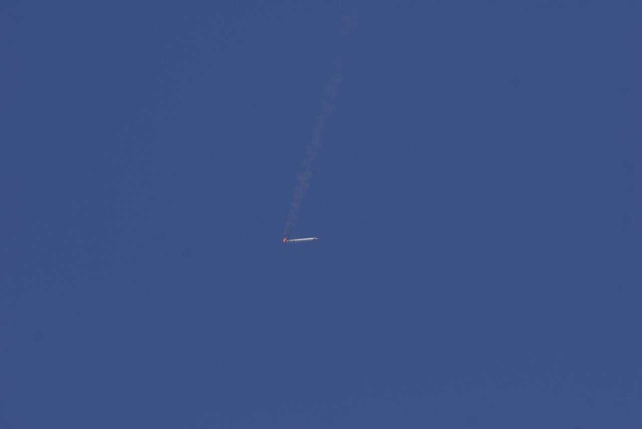 CAPE CANAVERAL, Fla. -- This image taken from the deck of NASA's SRB retrieval ship Freedom Star shows the right hand solid rocket booster from space shuttle Discovery's STS-124 launch falling through the atmosphere while burning off the remainder of its fuel. It will splash down into the Atlantic Ocean where the ship and its crew will recover it and tow it back through Port Canaveral for refurbishing for another launch. The STS-124 mission is the second of three flights launching components to complete the Japan Aerospace Exploration Agency's Kibo laboratory. The shuttle crew will install Kibo's large Japanese Pressurized Module and its remote manipulator system, or RMS. Photo credit: USA/Jeff Suter