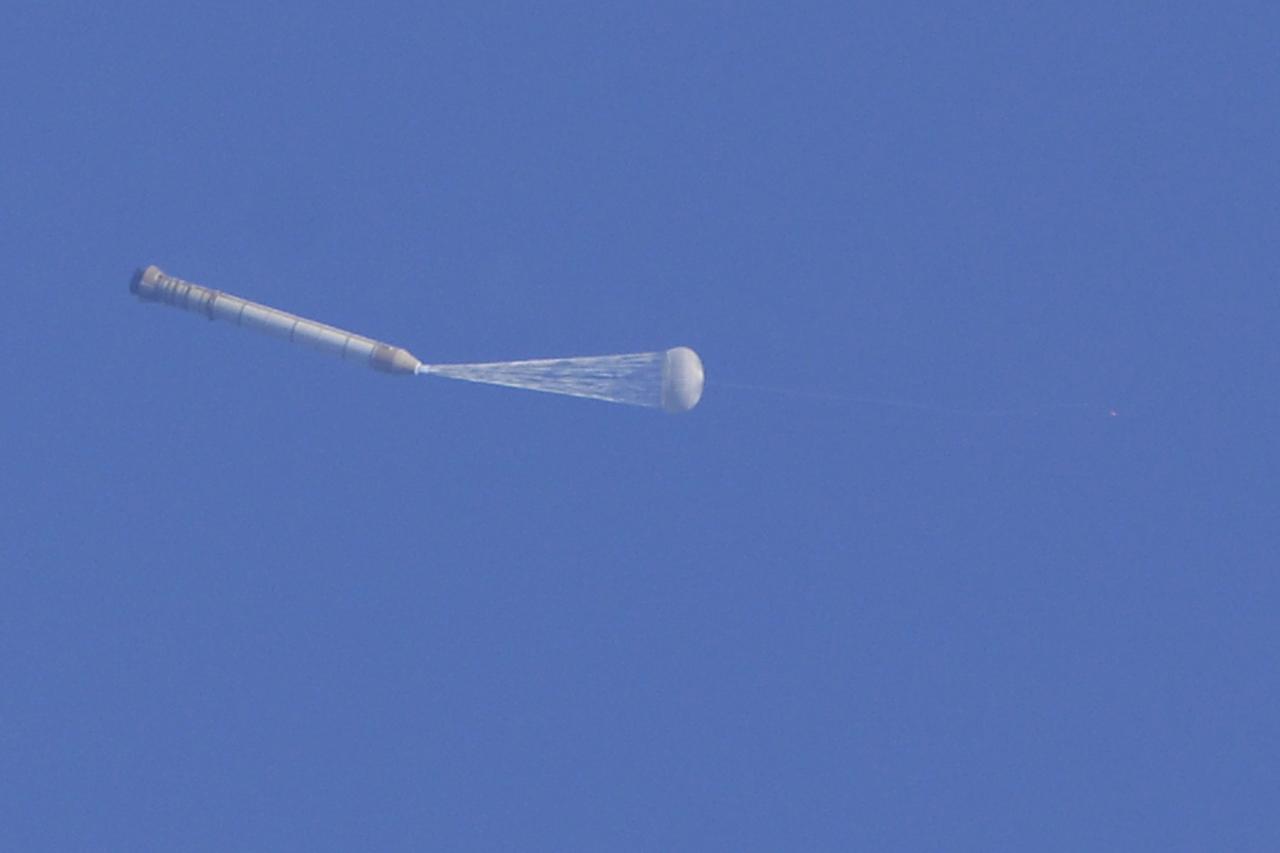 CAPE CANAVERAL, Fla. -- This image taken from the deck of NASA's SRB retrieval ship Freedom Star shows the right hand solid rocket booster from space shuttle Discovery's STS-124 launch falling through the atmosphere after its parachute has been deployed. It will splash down into the Atlantic Ocean where the ship and its crew will recover it and tow it back through Port Canaveral for refurbishing for another launch. The STS-124 mission is the second of three flights launching components to complete the Japan Aerospace Exploration Agency's Kibo laboratory. The shuttle crew will install Kibo's large Japanese Pressurized Module and its remote manipulator system, or RMS. Photo credit: USA/Jeff Suter