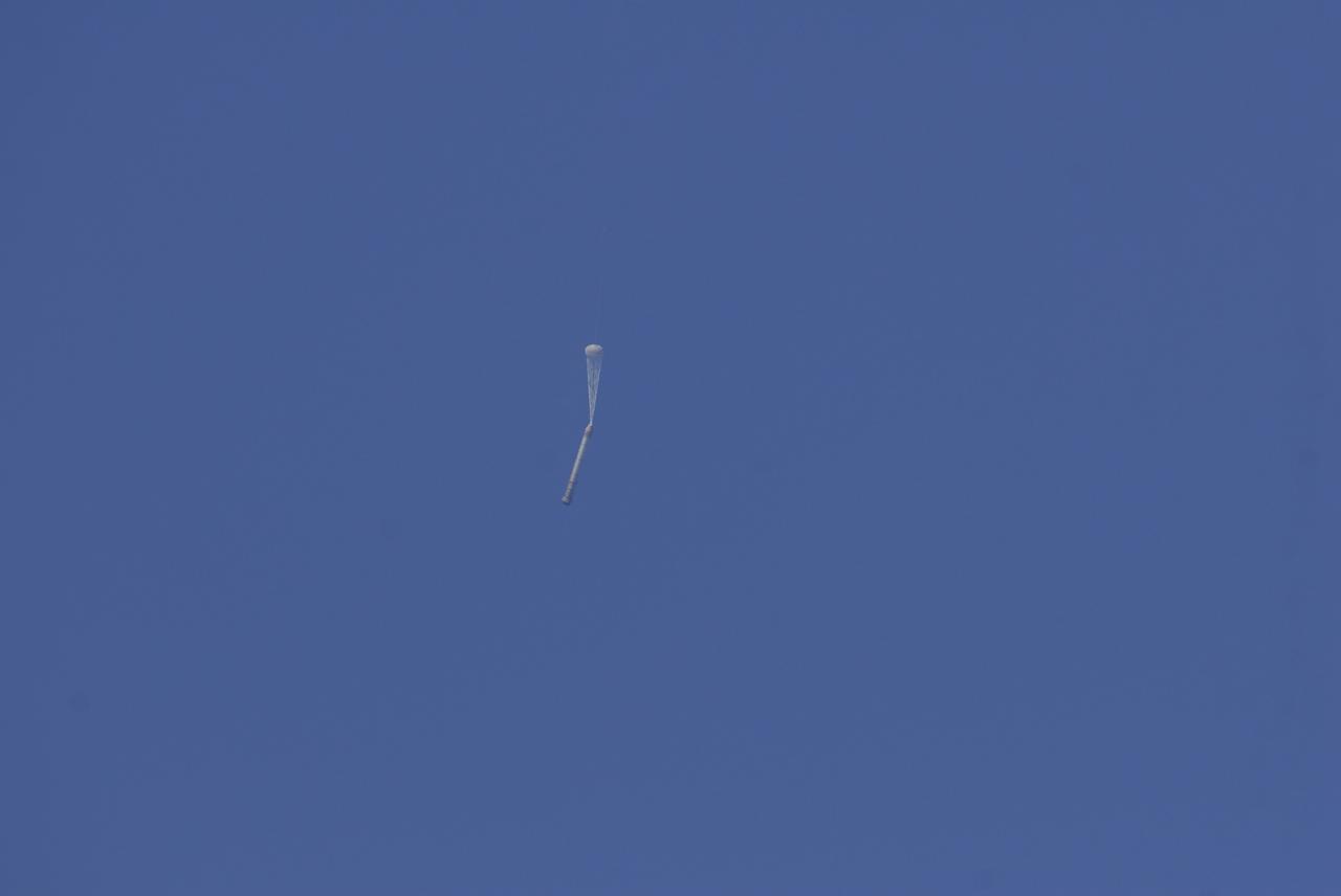 CAPE CANAVERAL, Fla. -- This image taken from the deck of NASA's SRB retrieval ship Freedom Star shows the right hand solid rocket booster from space shuttle Discovery's STS-124 launch falling through the atmosphere after its parachute has been deployed. It will splash down into the Atlantic Ocean where the ship and its crew will recover it and tow it back through Port Canaveral for refurbishing for another launch. The STS-124 mission is the second of three flights launching components to complete the Japan Aerospace Exploration Agency's Kibo laboratory. The shuttle crew will install Kibo's large Japanese Pressurized Module and its remote manipulator system, or RMS. Photo credit: USA/Jeff Suter