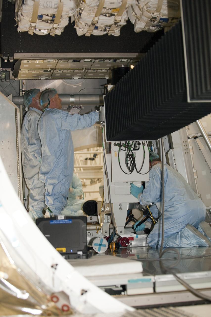 CAPE CANAVERAL, Fla. -- In the Space Station Processing Facility at NASA's Kennedy Space Center in Florida, technicians garbed in protective wear, commonly known as 'bunny suits,' check the installation of cargo inside the Raffaello multi-purpose logistics module for shuttle Atlantis' flight to the International Space Station.      Atlantis and its payload is being prepared for the STS-135 mission, which will deliver the Raffaello multi-purpose logistics module packed with supplies and spare parts to the station. Atlantis is targeted to launch June 28, and will be the last shuttle flight for the Space Shuttle Program. For more information visit, http://www.nasa.gov/mission_pages/shuttle/shuttlemissions/sts135/index.html. Photo credit: NASA/Frankie Martin