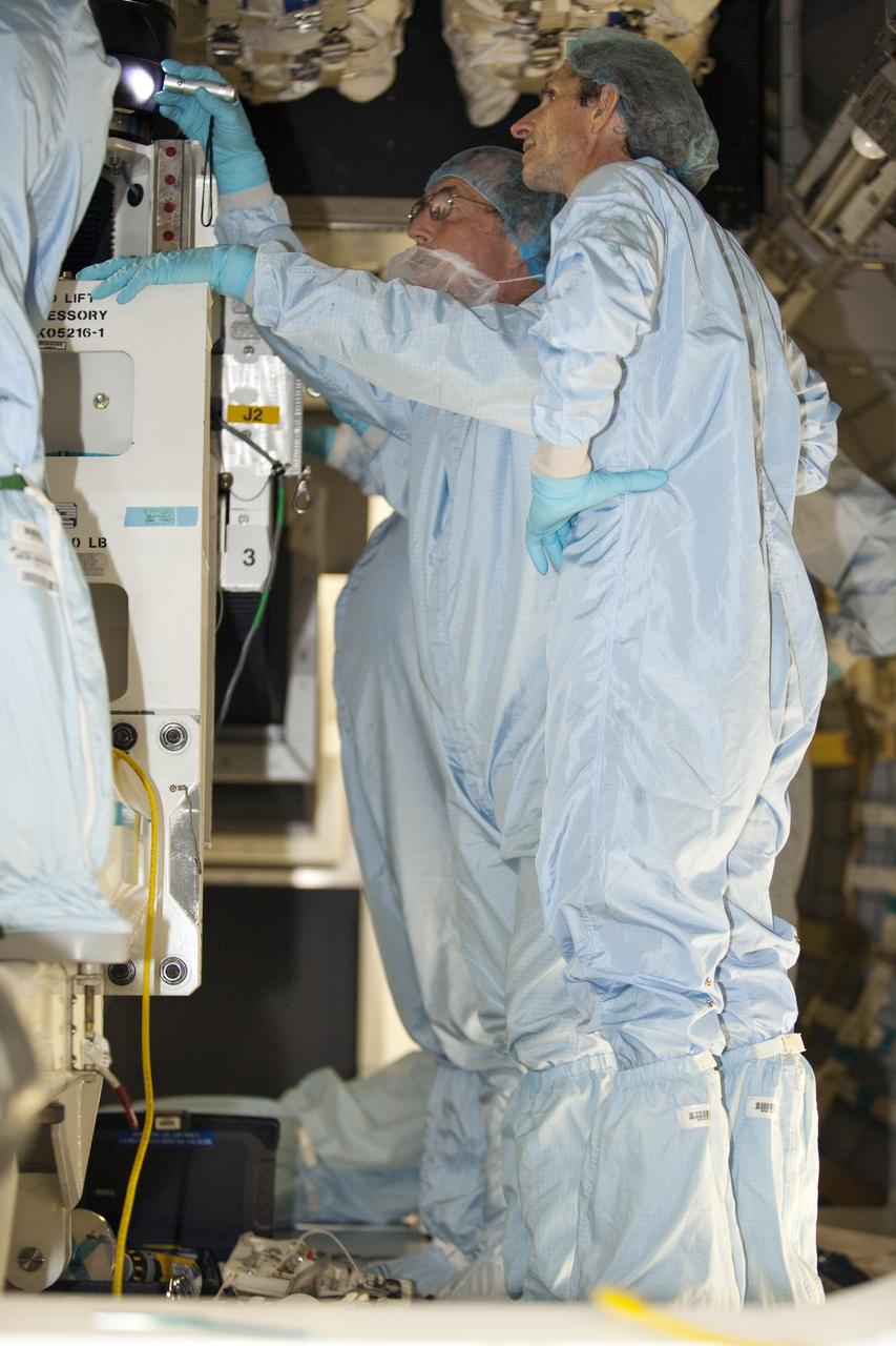 CAPE CANAVERAL, Fla. -- In the Space Station Processing Facility at NASA's Kennedy Space Center in Florida, technicians garbed in protective wear, commonly known as 'bunny suits,' check the installation of cargo inside the Raffaello multi-purpose logistics module for shuttle Atlantis' flight to the International Space Station.      Atlantis and its payload is being prepared for the STS-135 mission, which will deliver the Raffaello multi-purpose logistics module packed with supplies and spare parts to the station. Atlantis is targeted to launch June 28, and will be the last shuttle flight for the Space Shuttle Program. For more information visit, http://www.nasa.gov/mission_pages/shuttle/shuttlemissions/sts135/index.html. Photo credit: NASA/Frankie Martin