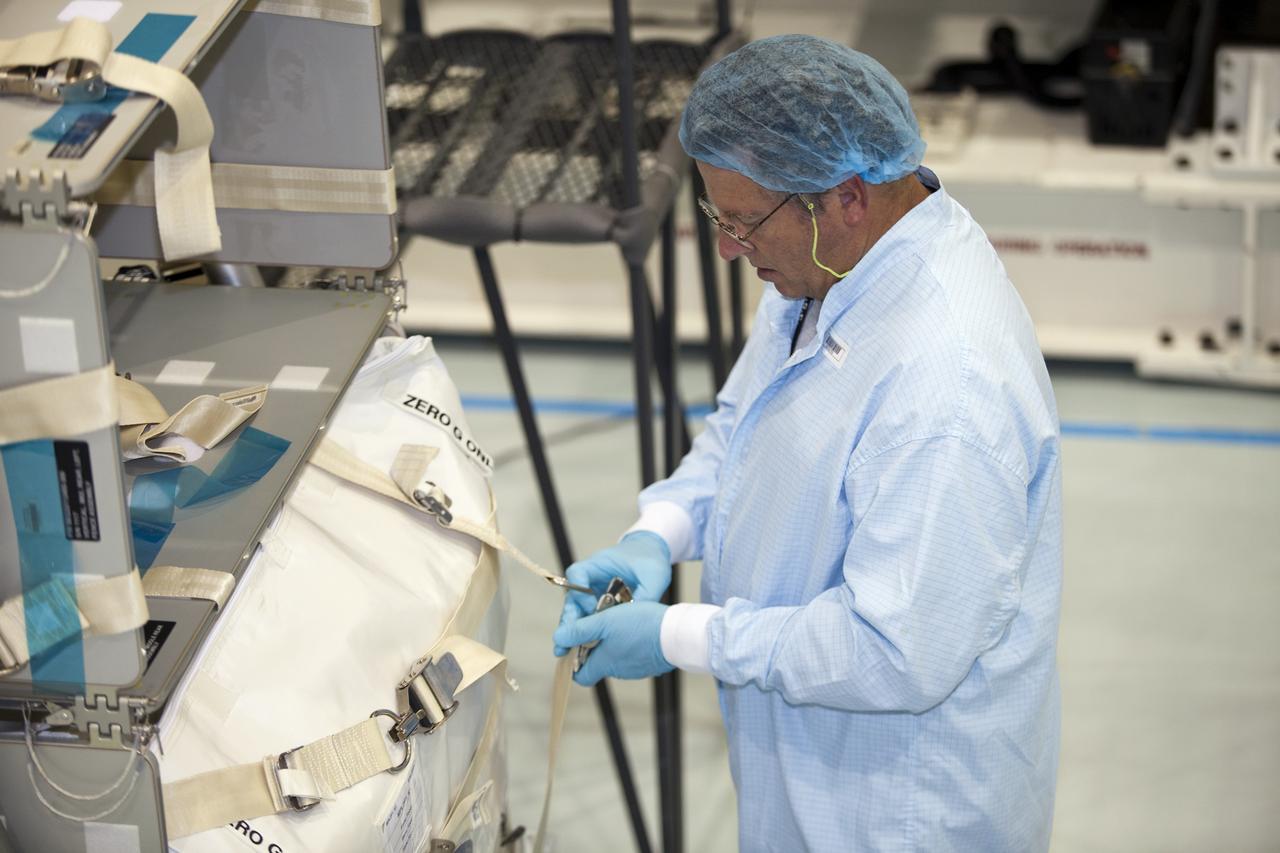 CAPE CANAVERAL, Fla. -- In the Space Station Processing Facility at NASA's Kennedy Space Center in Florida, a technician garbed in protective wear, commonly known as a 'bunny suit,' secures the cargo that will be installed inside the Raffaello multi-purpose logistics module for shuttle Atlantis' flight to the International Space Station. Atlantis and its payload is being prepared for the STS-135 mission, which will deliver the Raffaello multi-purpose logistics module packed with supplies and spare parts to the station. Atlantis is targeted to launch June 28, and will be the last shuttle flight for the Space Shuttle Program. For more information visit, http://www.nasa.gov/mission_pages/shuttle/shuttlemissions/sts135/index.html. Photo credit: NASA/Frankie Martin