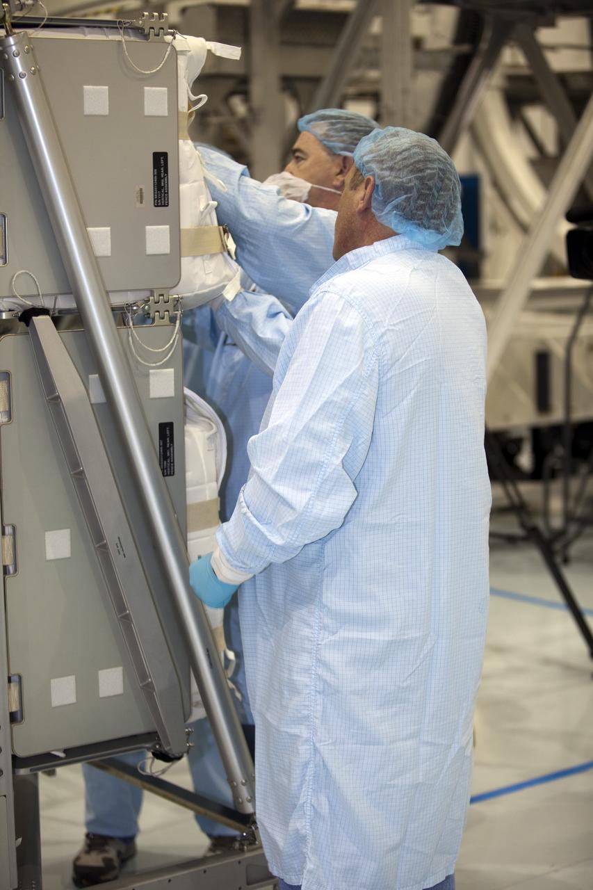 In the Space Station Processing Facility at NASA's Kennedy Space Center in Florida, technicians garbed in protective wear, commonly known as 'bunny suits,' secure the cargo that will be installed inside the Raffaello multi-purpose logistics module for shuttle Atlantis' flight to the International Space Station. Atlantis and its payload is being prepared for the STS-135 mission, which will deliver the Raffaello multi-purpose logistics module packed with supplies and spare parts to the station. Atlantis is targeted to launch June 28, and will be the last shuttle flight for the Space Shuttle Program. For more information visit, http://www.nasa.gov/mission_pages/shuttle/shuttlemissions/sts135/index.html. Photo credit: NASA/Frankie Martin