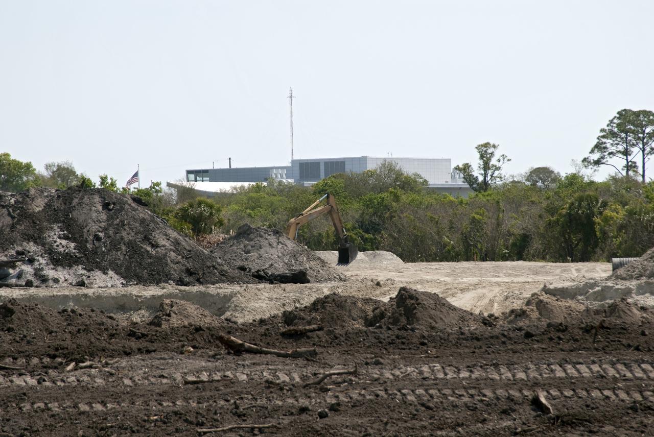 CAPE CANAVERAL, Fla. -- Crews continue to clear land and prepare for the construction of a new road at the Exploration Park site near the Space Life Sciences Laboratory (SLSL) at NASA's Kennedy Space Center in Florida. The first phase will encompass 60 acres just outside Kennedy’s security gates. Nine buildings will provide 350,000-square feet of work space, including educational, office, research and lab, and high-bay facilities. Each building is expected to be certified in the U.S. Green Building Council’s Leadership in Environmental and Energy Design (LEED). Exploration Park is designed to be a strategically located complex, adjacent to the SLSL, for servicing diverse tenants and uses that will engage in activities to support space-related activities of NASA, other government agencies and the U.S. commercial space industry. It also is expected to bring new aerospace work to the Space Coast. The SLSL will be the anchor facility for the park, which is expected to open its first new facility in early 2012. Photo credit: NASA/Jim Grossmann